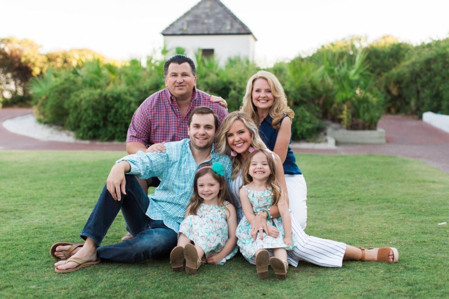10 Year Wedding Anniversary by popular Nashville lifestyle blog, Hello Happiness: image of a family sitting together on the grass. 