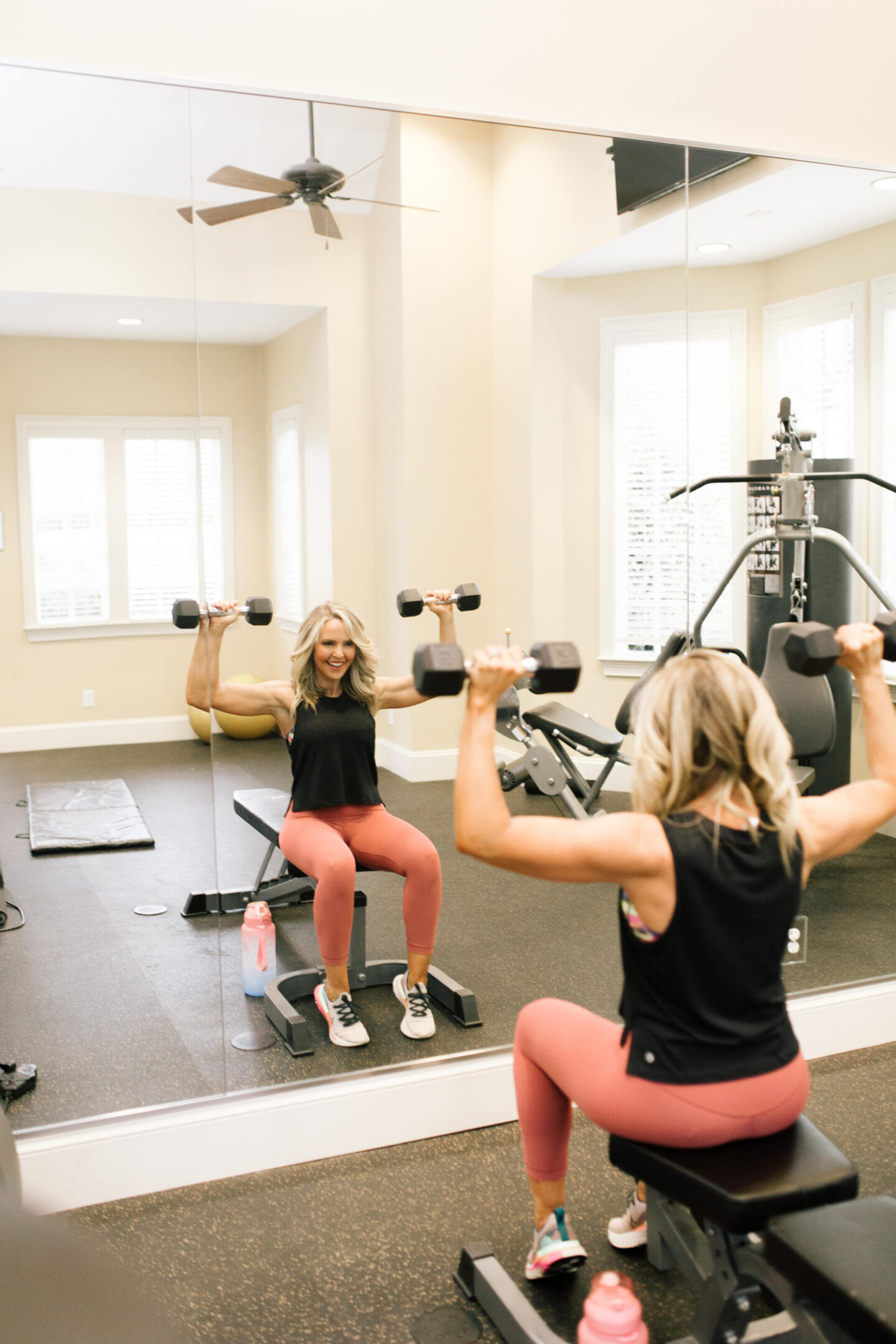 Collaborations and Partnerships by popular Nashville lifestyle blog, Hello Happiness: image of a woman sitting on a bench and lifting hand weights in a gym.
