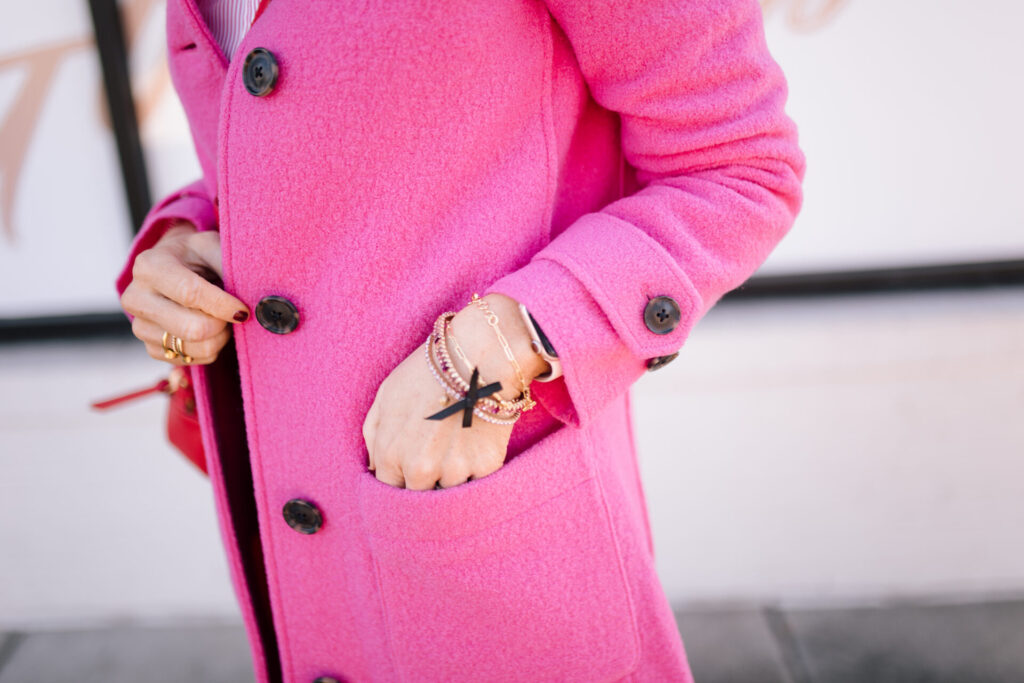 J. Crew Holiday by popular Nashville fashion blog, Hello Happiness: image of Natasha Stoneking standing outside and wearing a J. CrewDemi Boot Dark Jeans, Striped Poplin Shirt, Pink Lady Wool Coat, and Saturday Sneakers with Leopard Detail.