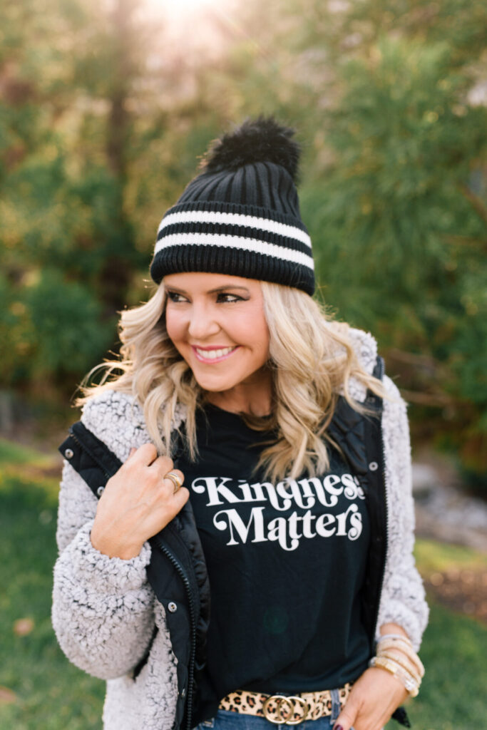 Women's Winter Coats by popular Nashville fashion blog, Hello Happiness: image of Natasha wearing a sherpa bomber jacket with a black t-shirt, jeans, and black beanie. 