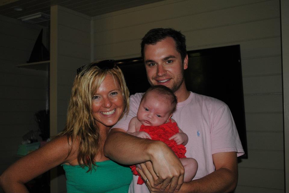 10 Year Wedding Anniversary by popular Nashville lifestyle blog, Hello Happiness: image of a mom and dad standing together and holding a newborn baby.