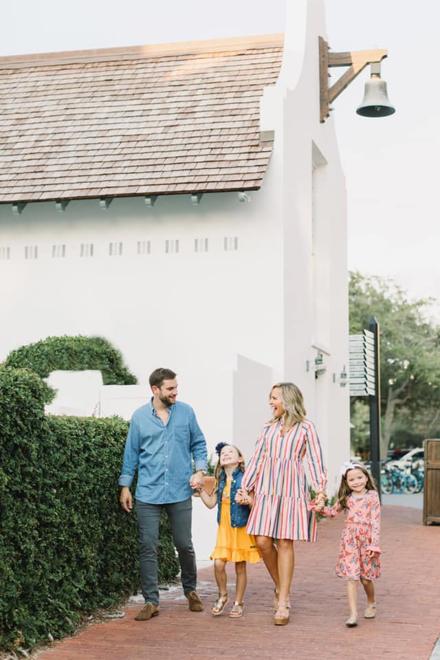 10 Year Wedding Anniversary by popular Nashville lifestyle blog, Hello Happiness: image of a mom and dad and their two young daughters holding hands and walking down a brick paved sidewalk.