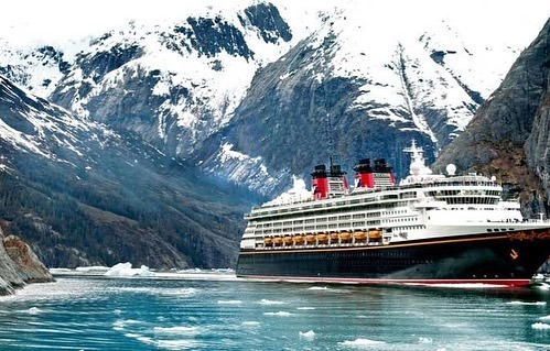 How to Support Small Business: image of a cruise ship next to some snow capped mountains.