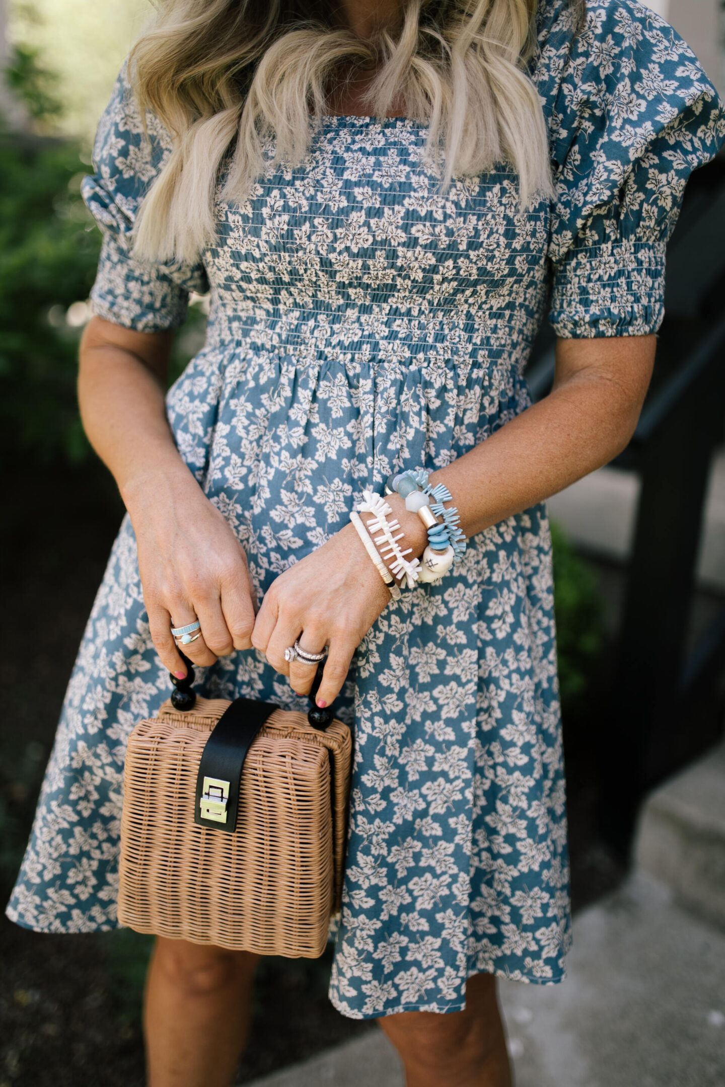 Summer Dress by popular Nashville fashion blog, Hello Happiness: image of a woman standing on some cement stairs and wearing a pastoral dress, Glyn espadrilles, and holding a woven tote.