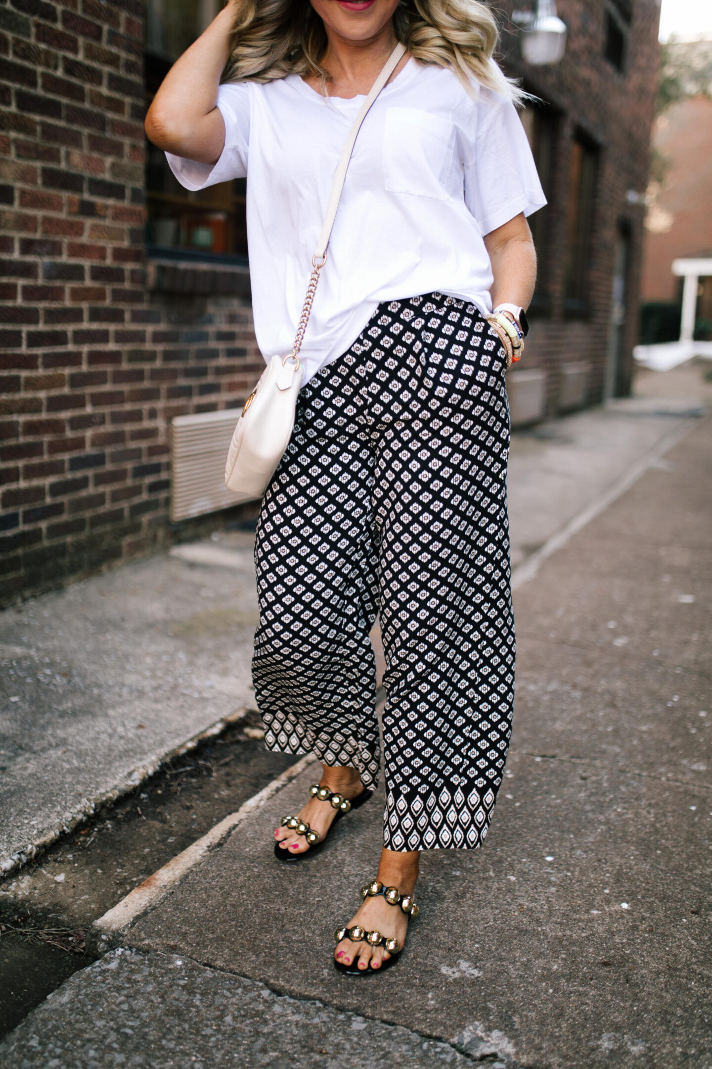 4th of July Deals by popular Nashville life and style blog, Hello Happiness: image of Natasha Stoneking wearing a pair of Steve Madden Chrishelle Black Slides.