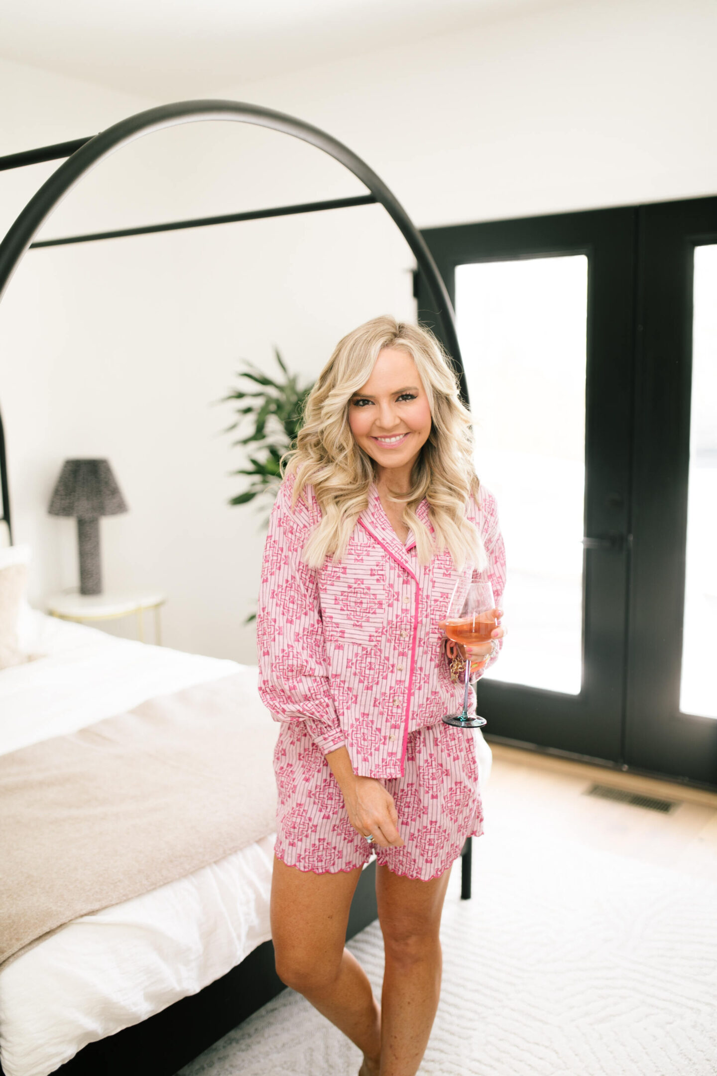 Anthropologie Sale by popular Nashville life and style blog, Hello Happiness: image of Natasha Stoneking wearing a pink pajama set and holding a wine glass.
