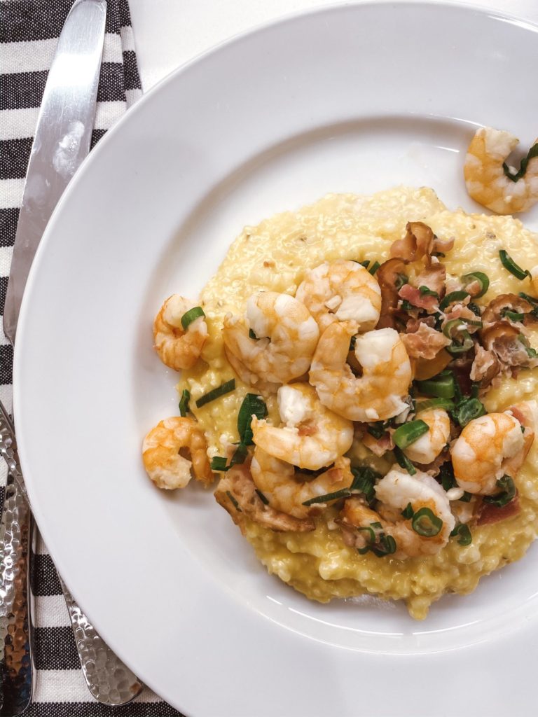 Shrimp and Grits with Bacon by popular Nashville lifestyle blog, Hello Happiness: image of shrimp and grits with bacon on a white plate. 