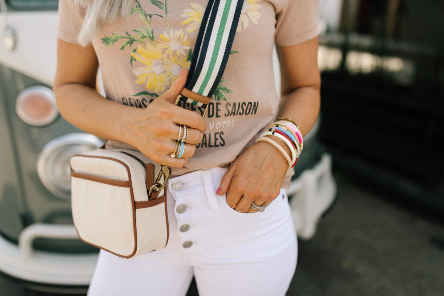 J Crew Clothing by popular Nashville fashion blog, Hello Happiness: image of a woman wearing a J Crew vintage cotton fleurs savages graphic t-shirt and white jeans. 