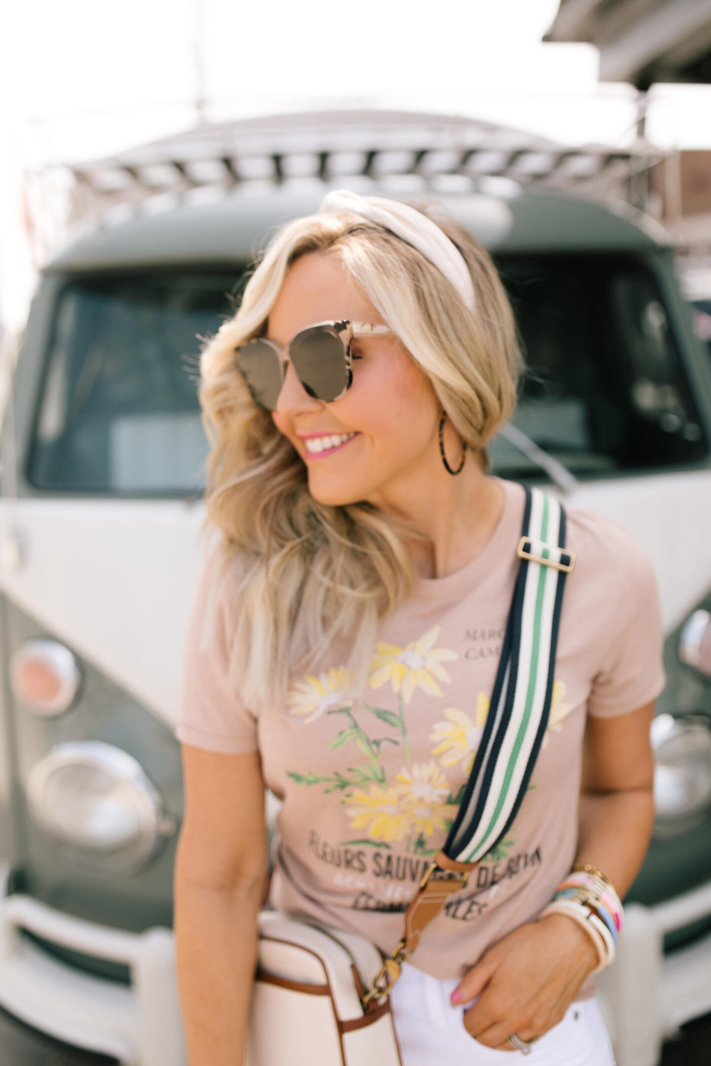 J Crew Clothing by popular Nashville fashion blog, Hello Happiness: image of a woman wearing a J Crew vintage cotton fleurs savages graphic t-shirt and white jeans.