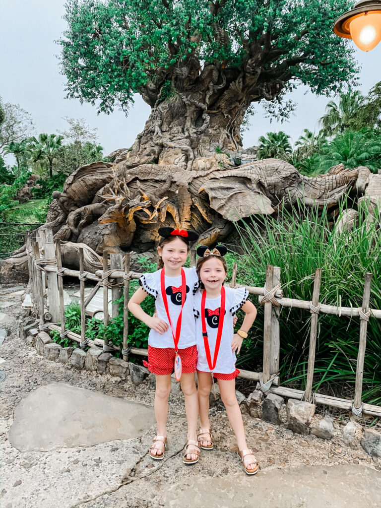 Disney Creators Celebration by poplar Nashville travel blog, Hello Happiness: image of two girls at Animal Kingdom and wearing Disney Minnie Mouse ears, Smocked Auctions MOUSE EARS APPLIQUE SHORT SET RED POLKA DOT, and Zappos Birkenstock Kids Arizona. 