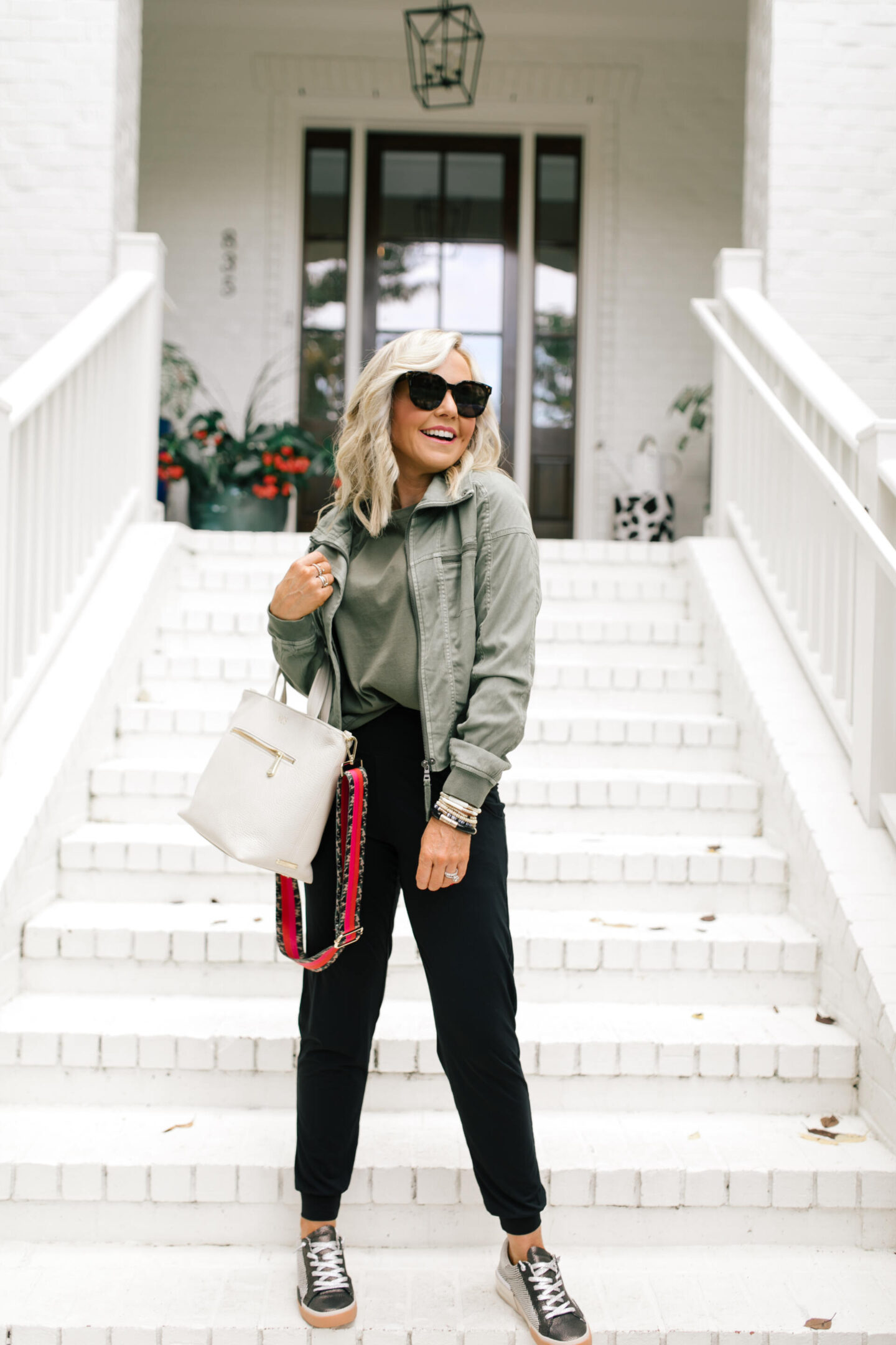 Fall Outfits by popular Nashville fashion blog, Hello Happiness: image of Natasha Stoneking wearing a Evereve Morrison jacket, commando butter jogger pants, Zina sneakers, and Shoulder pad tee. 