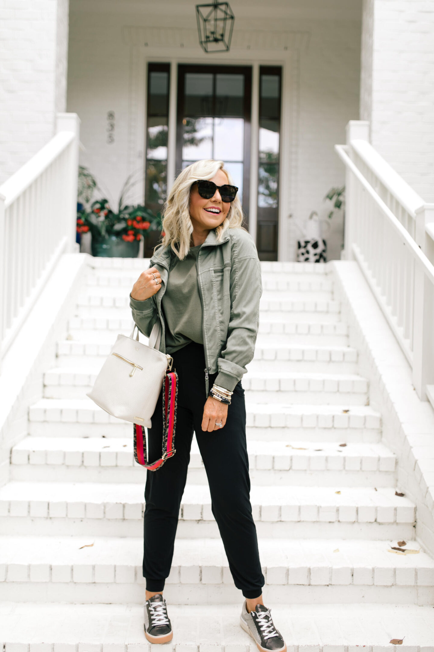 Fall Outfits by popular Nashville fashion blog, Hello Happiness: image of Natasha Stoneking wearing a Evereve Morrison jacket, commando butter jogger pants, Zina sneakers, and Shoulder pad tee.