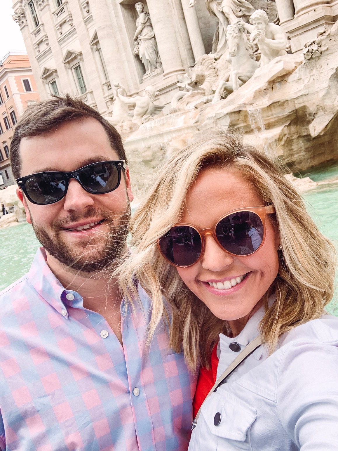 10 Year Wedding Anniversary by popular Nashville lifestyle blog, Hello Happiness: image of a husband and wife standing in front of the Tripoli fountain in Rome, Italy.