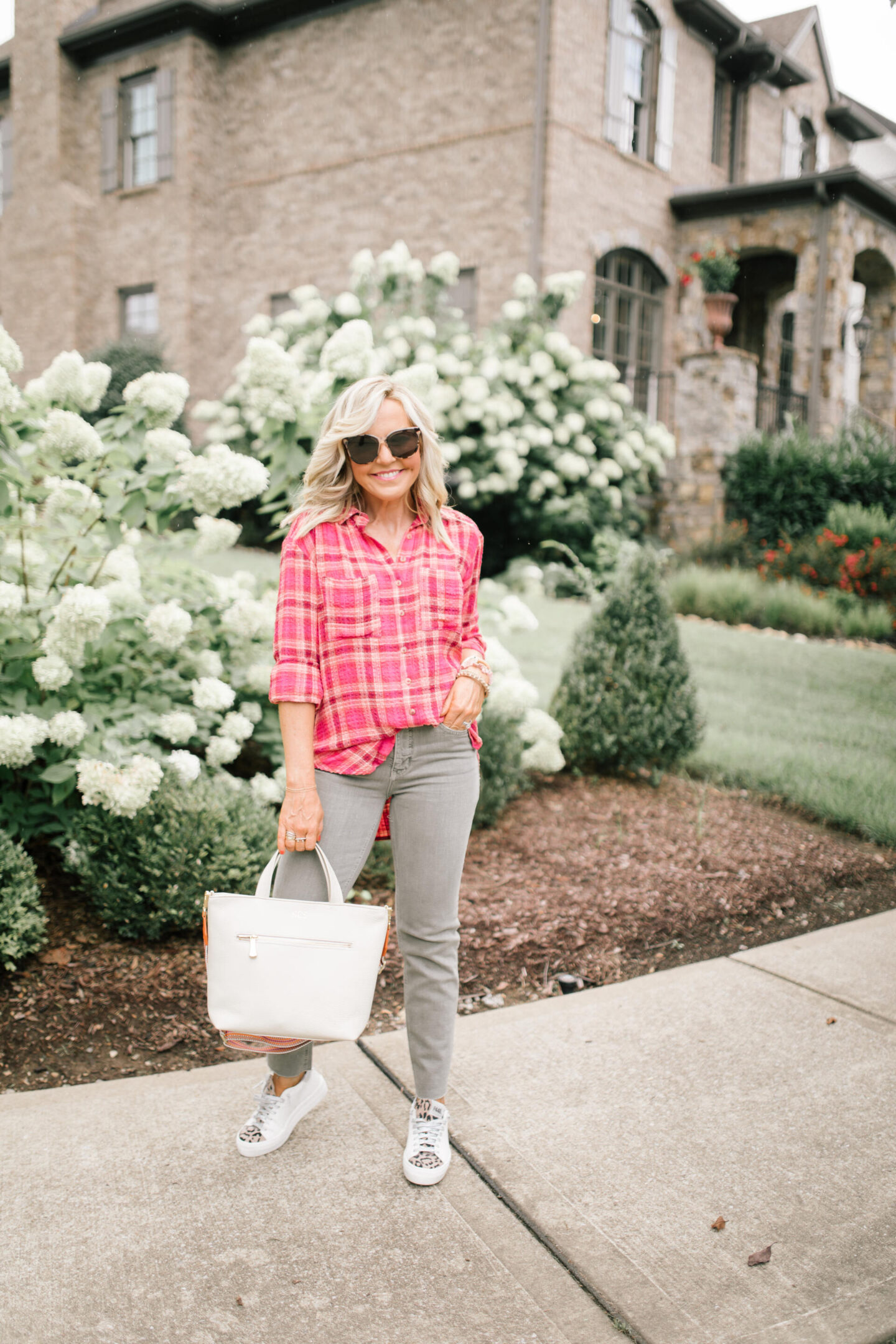 Pilcro Jeans by popular Nashville fashion blog, Hello Happiness: image of Natasha Stoneking wearing Pilcro vintage wash jeans, plaid tunic top, and p448 sneakers. 