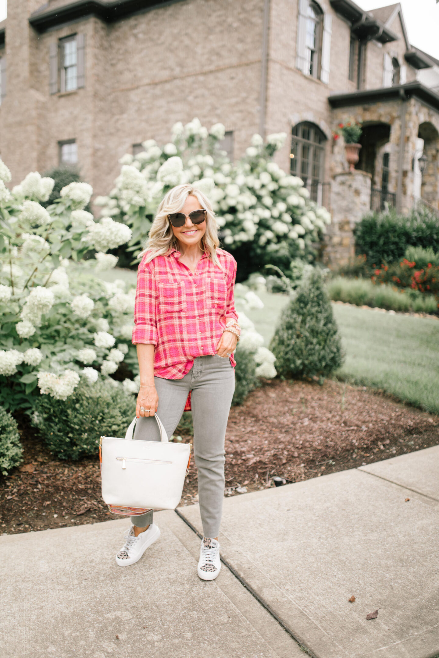 Pilcro Jeans by popular Nashville fashion blog, Hello Happiness: image of Natasha Stoneking wearing Pilcro vintage wash jeans, plaid tunic top, and p448 sneakers.
