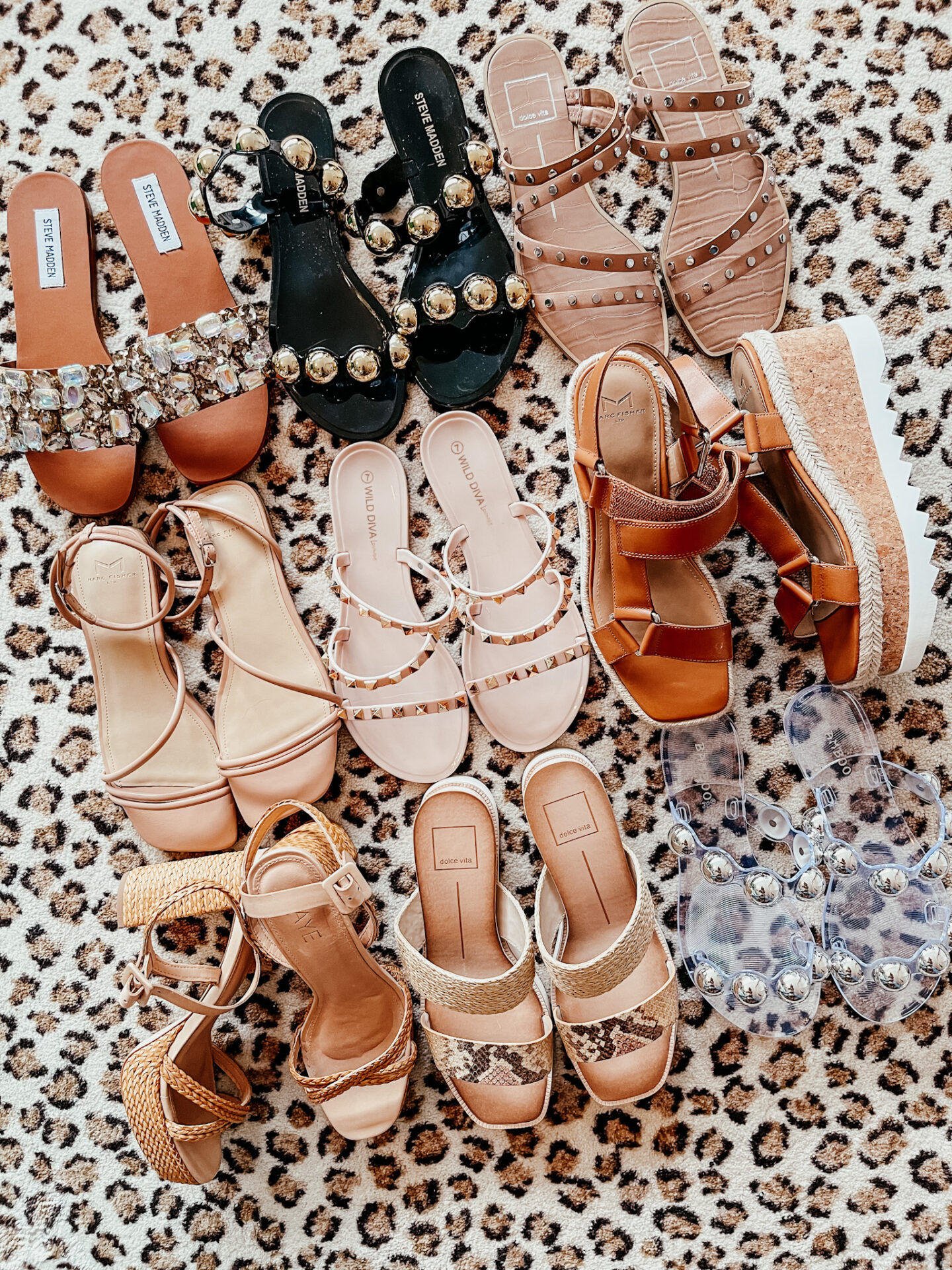 Spring Break Outfits by popular Nashville fashion blog, Hello Happiness: image of various flat and wedge slide sandals on a leopard print rug.