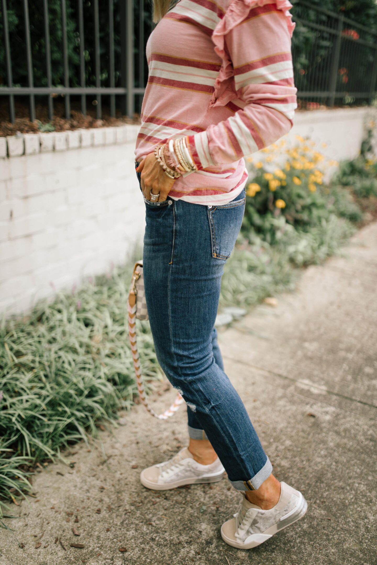 Pilcro Jeans by popular Nashville fashion blog, Hello Happiness: image of Natasha Stoneking wearing Pilcro slim boyfriend jeans, ruffle open back top, and p448 sneakers. 