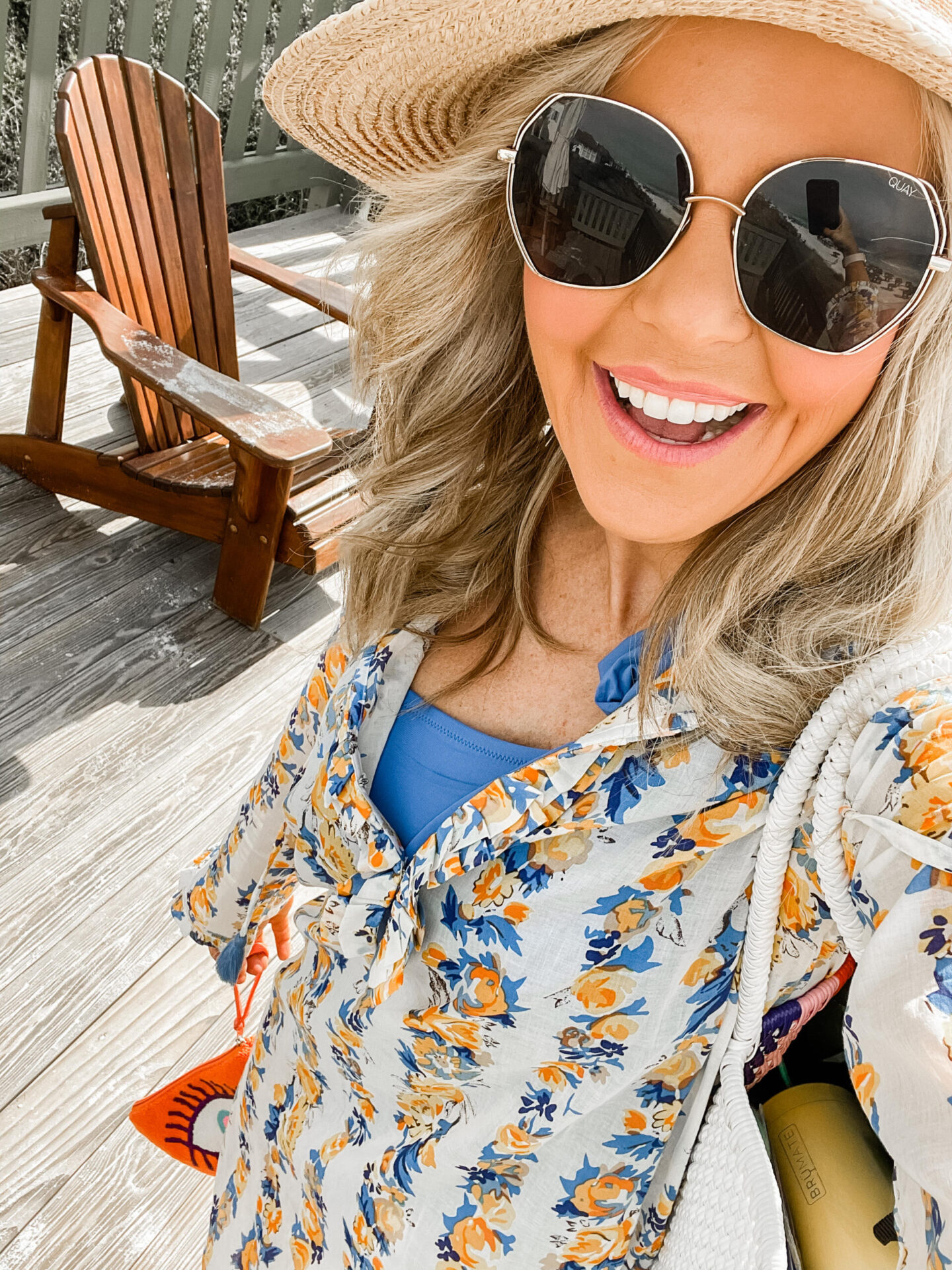 Spring Break Outfits by popular Nashville fashion blog, Hello Happiness: image of Natasha Stoneking wearing a floral coverup and tie shoulder one piece swimsuit.