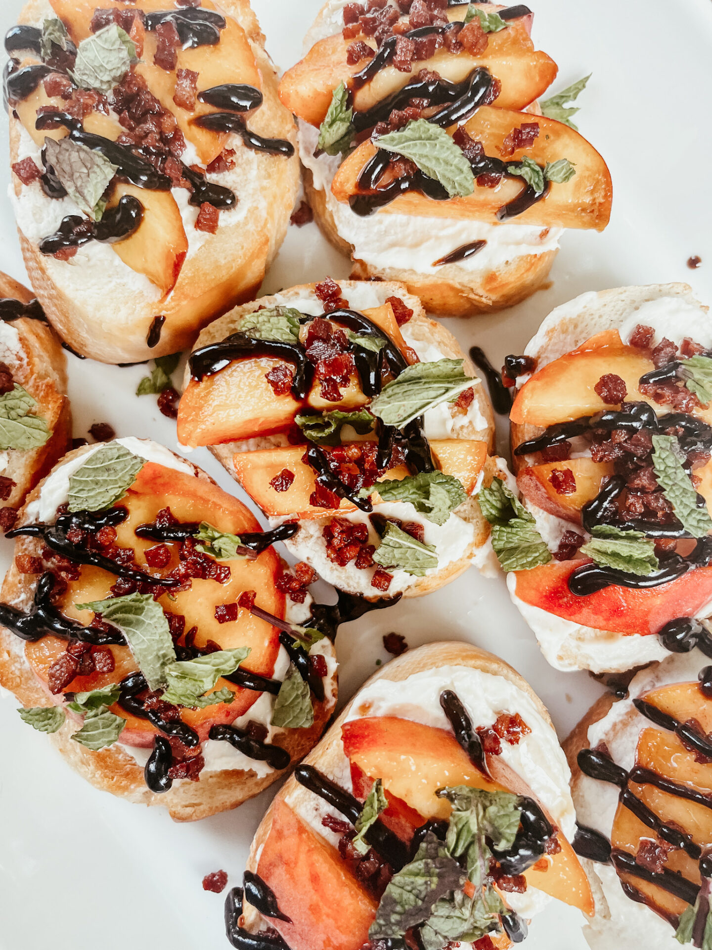 Goat Cheese Crostini by popular Nashville lifestyle blog, Hello Happiness: image of peach and goat cheese crostini.