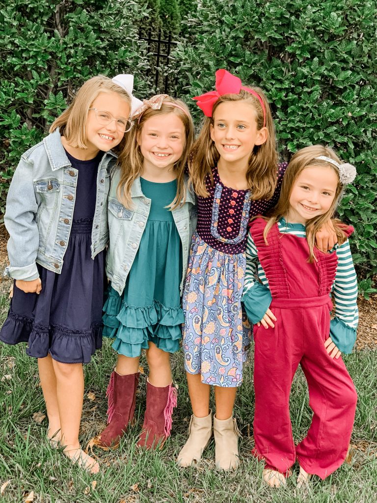 Caroline and Carson's Daily Style... Fall Fashion 2019 Edition by popular Nashville fashion blog, Hello Happiness: image of 4 little girls standing together and wearing Matilda Jane Clothing Long-Sleeved Lap Dress, Matilda Jane Clothing Veggie Stand Dress, Matilda Jane Clothing To Market Dress, and Matilda Jane Clothing Perfect Produce Top.