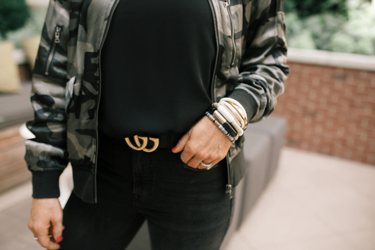 Fall Outfits by popular Nashville fashion blog, Hello Happiness: image of Natasha Stoneking wearing a Evereve camo bomber jacket, chiffon cami and good classic denim.