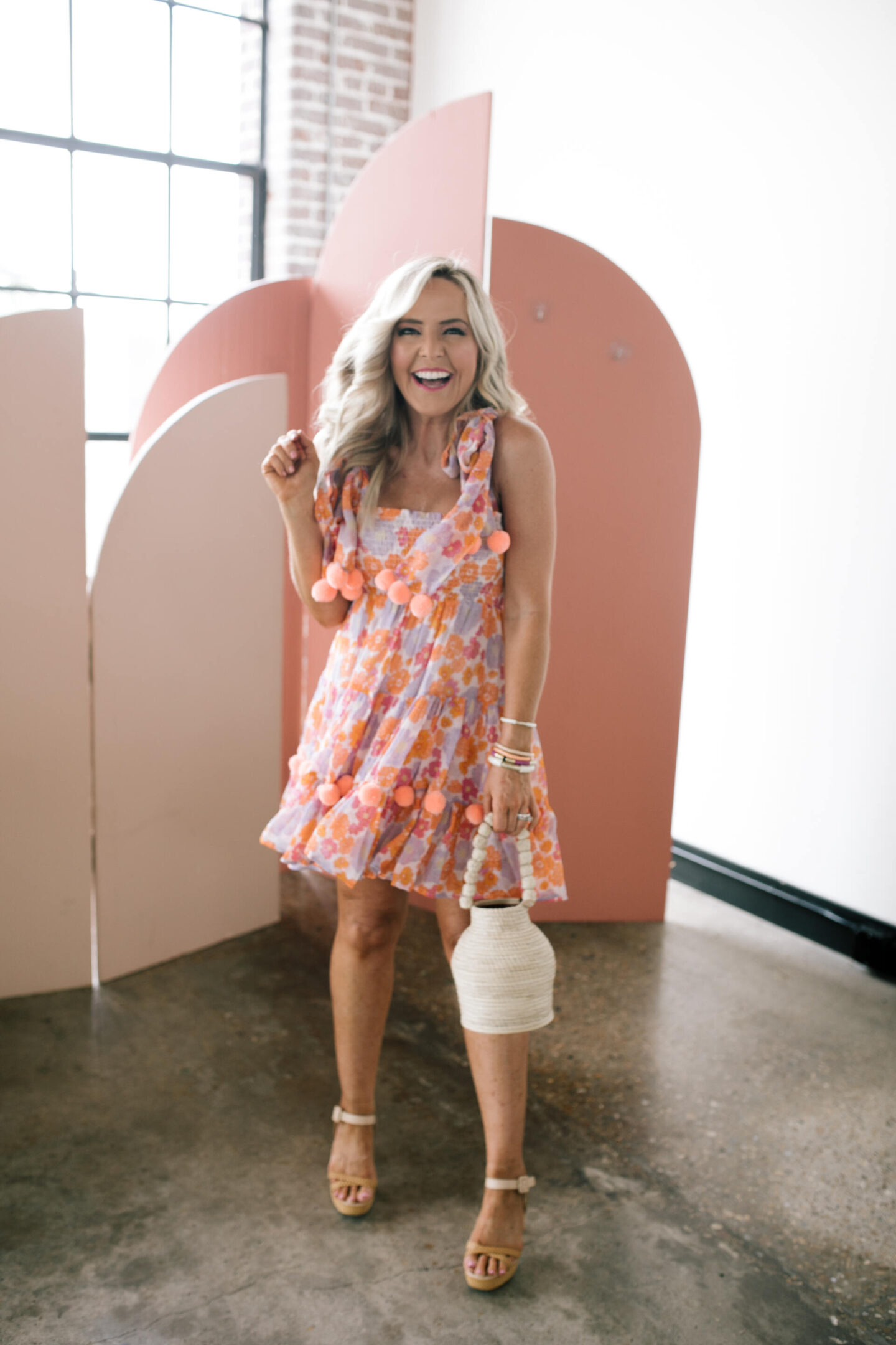 Revolve Clothing by popular Nashville fashion blog, Hello Happiness: image of Natasha Stoneking wearing a Revolve Pippa short dress, Revolve Raye Platform sandals, Revolve Kaanas bucket bag, and some stack bracelets.