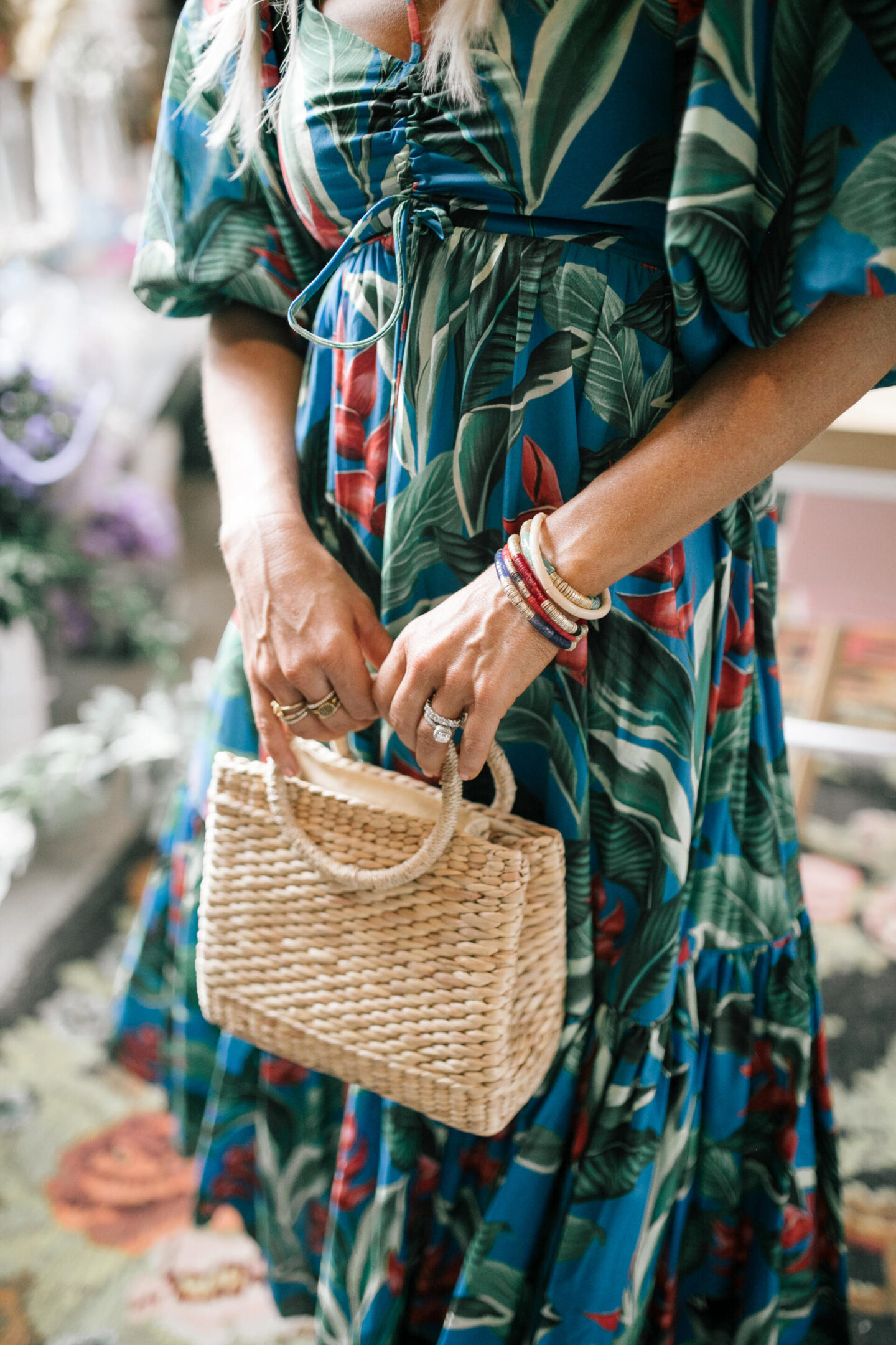 Birthday Wishlist by popular Nashville life and style blog, Hello Happiness: image of a woman wearing a Dream Garden midi dress and holding a woven hand bag.