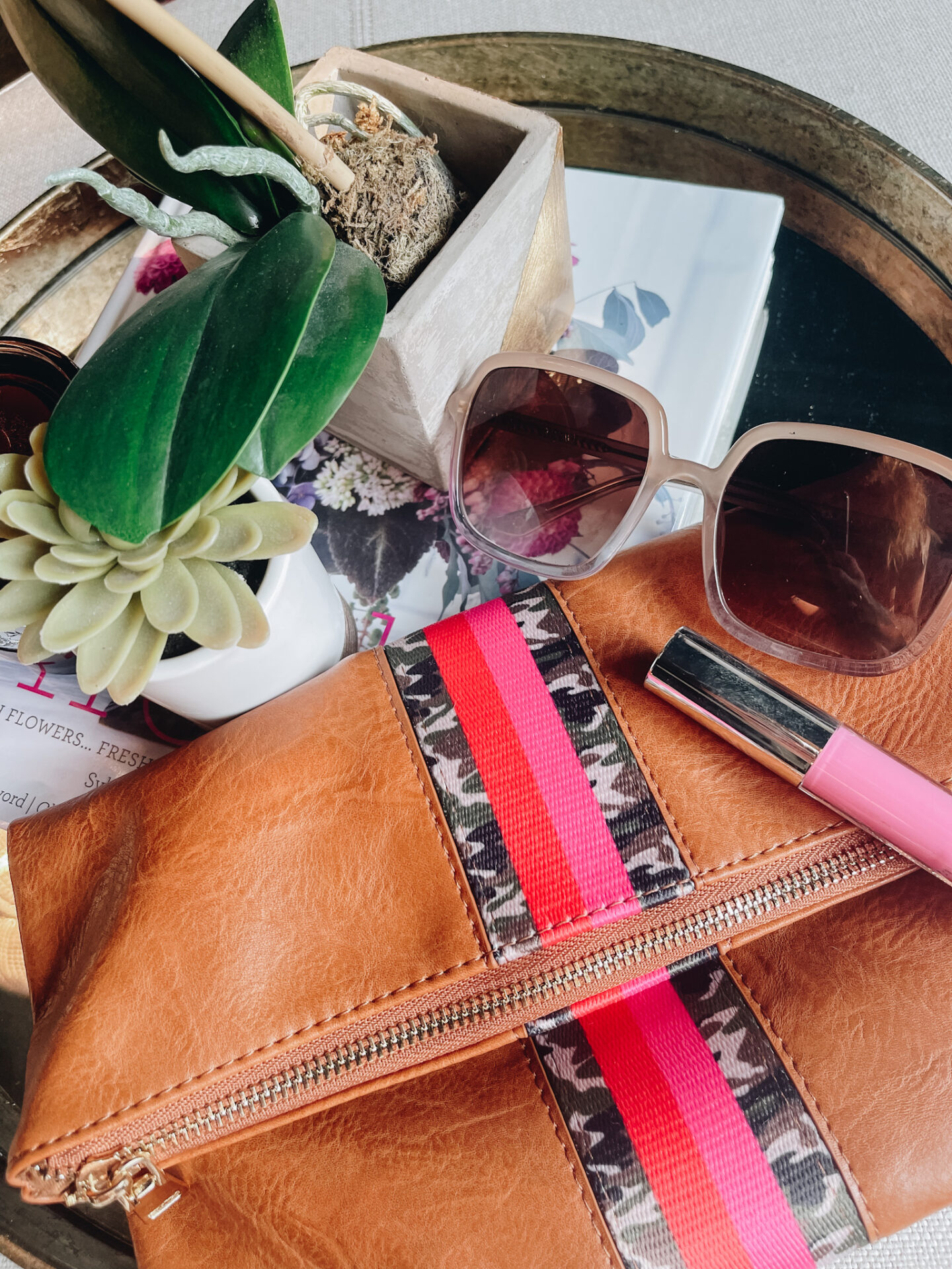 Foldover Clutch by popular Nashville fashion blog, Hello Happiness: image of a camo foldover clutch, square frame sunglasses, and pink lipgloss.