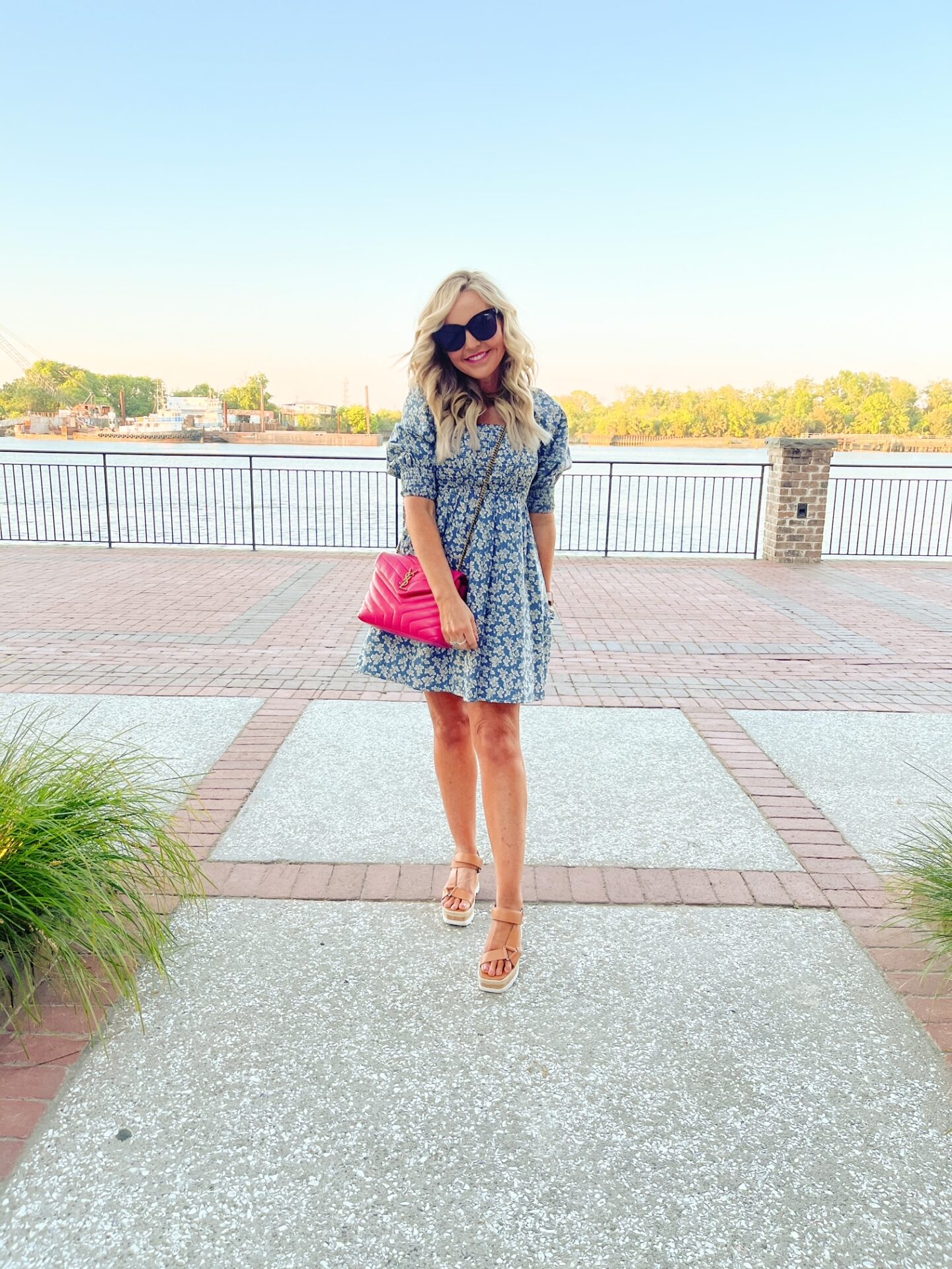 Girls Getaway by popular Nashville travel blog, Hello Happiness: image of Natasha Stoneking wearing a blue and white print floral mini dress, tan espadrilles and hold a pink YSL bag. 