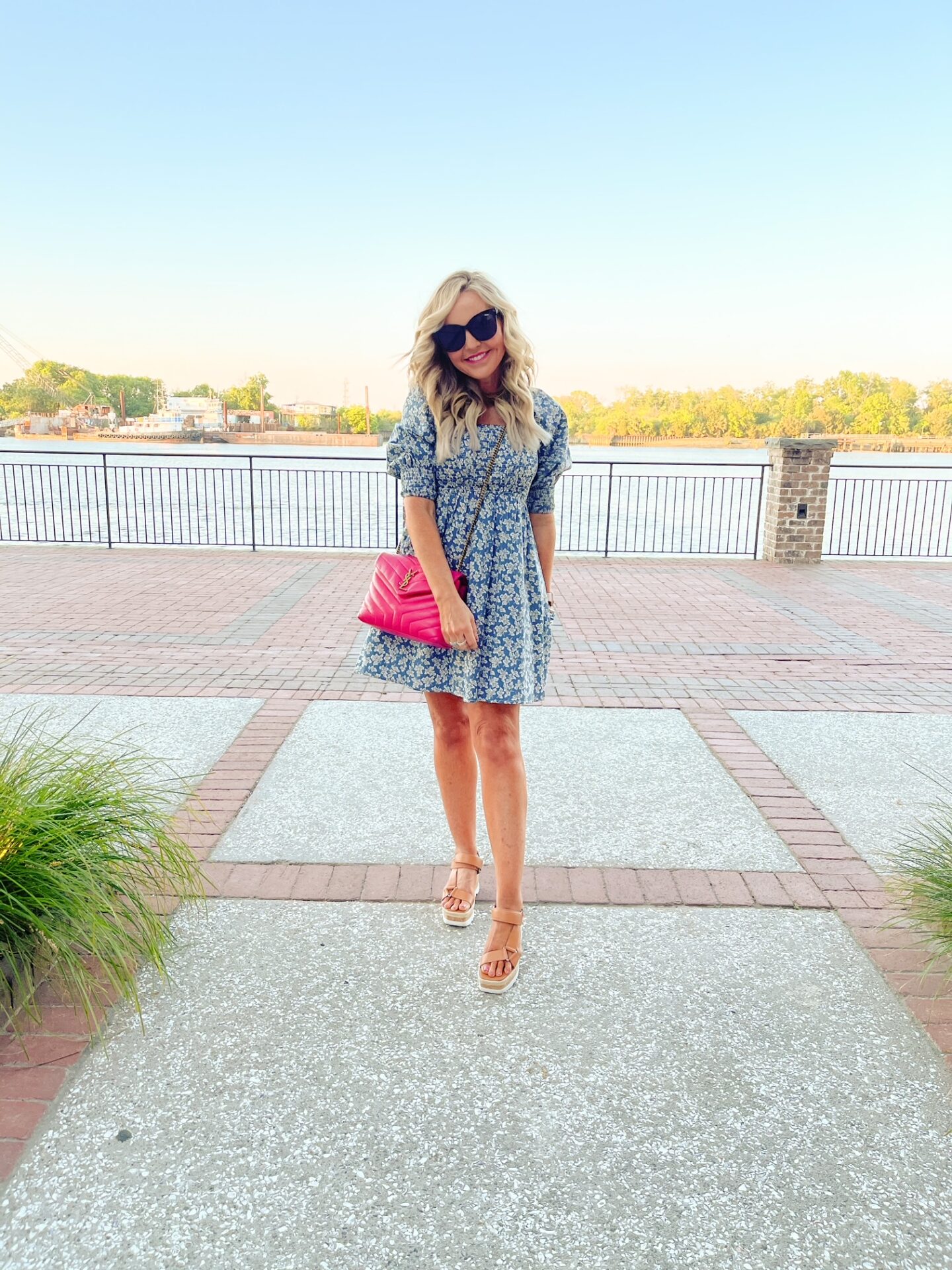 Girls Getaway by popular Nashville travel blog, Hello Happiness: image of Natasha Stoneking wearing a blue and white print floral mini dress, tan espadrilles and hold a pink YSL bag.