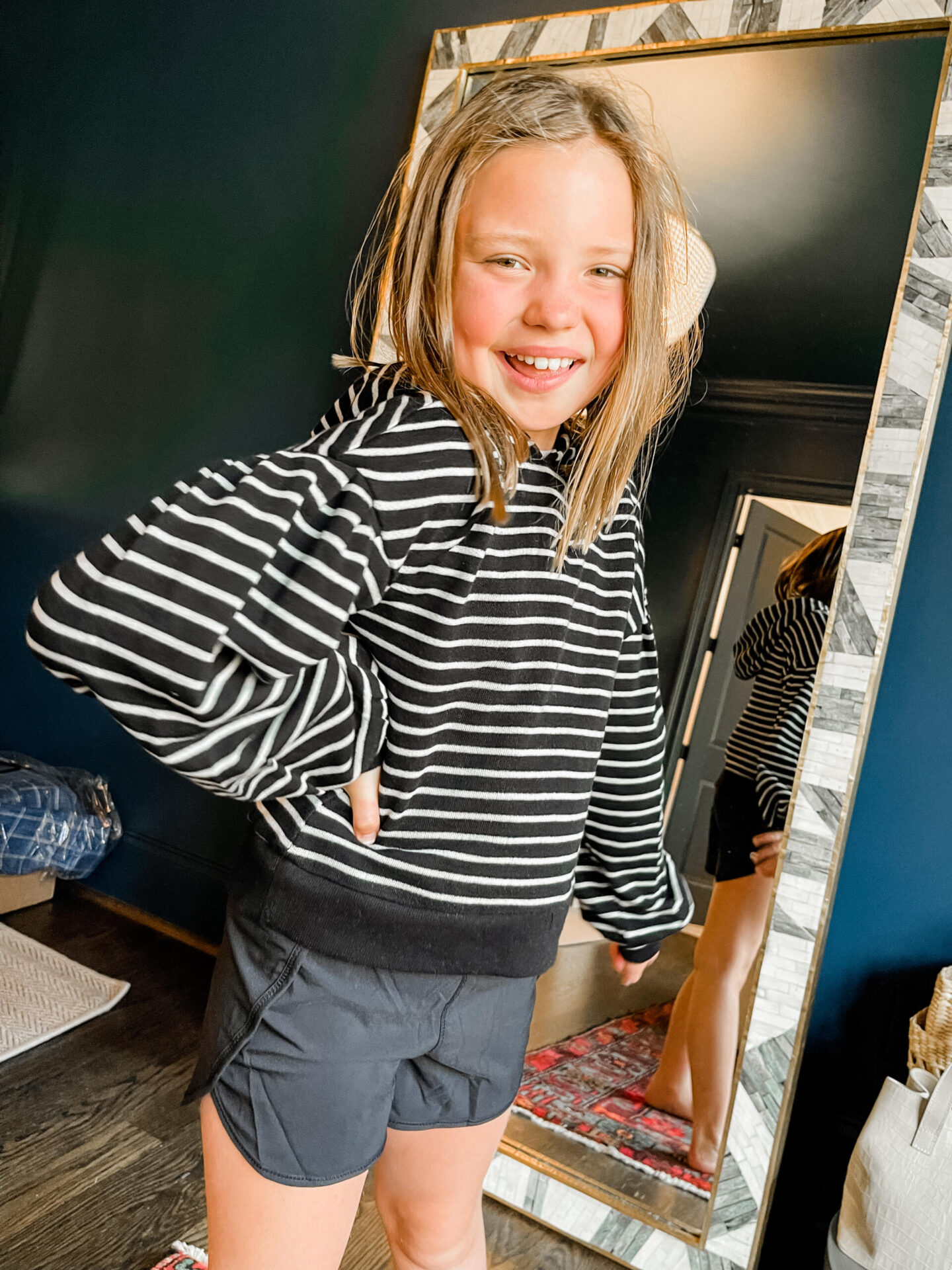 Back to School Essentials by popular Nashville lifestyle blog, Hello Happiness: image of a young girl wearing a balloon sleeve hoodie and black athletic shorts.