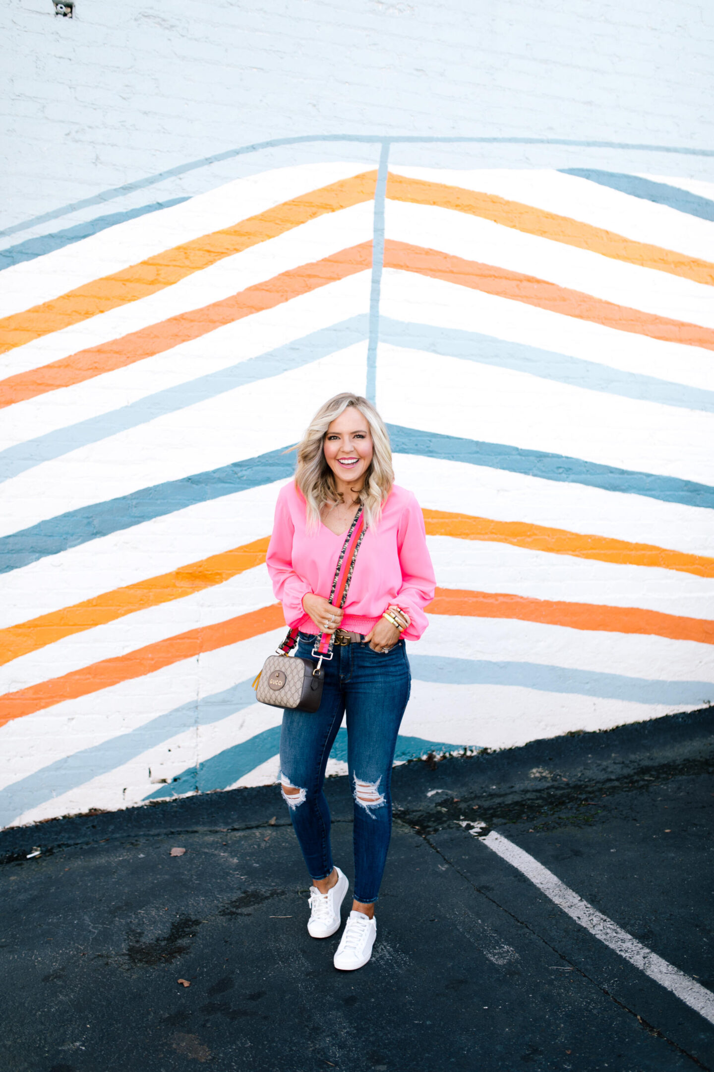 Pink Fashion by popular Nashville fashion blog, Hello Happiness: image of a woman wearing a Pink Hibiscus V-Neck Top from Sail to Sable.