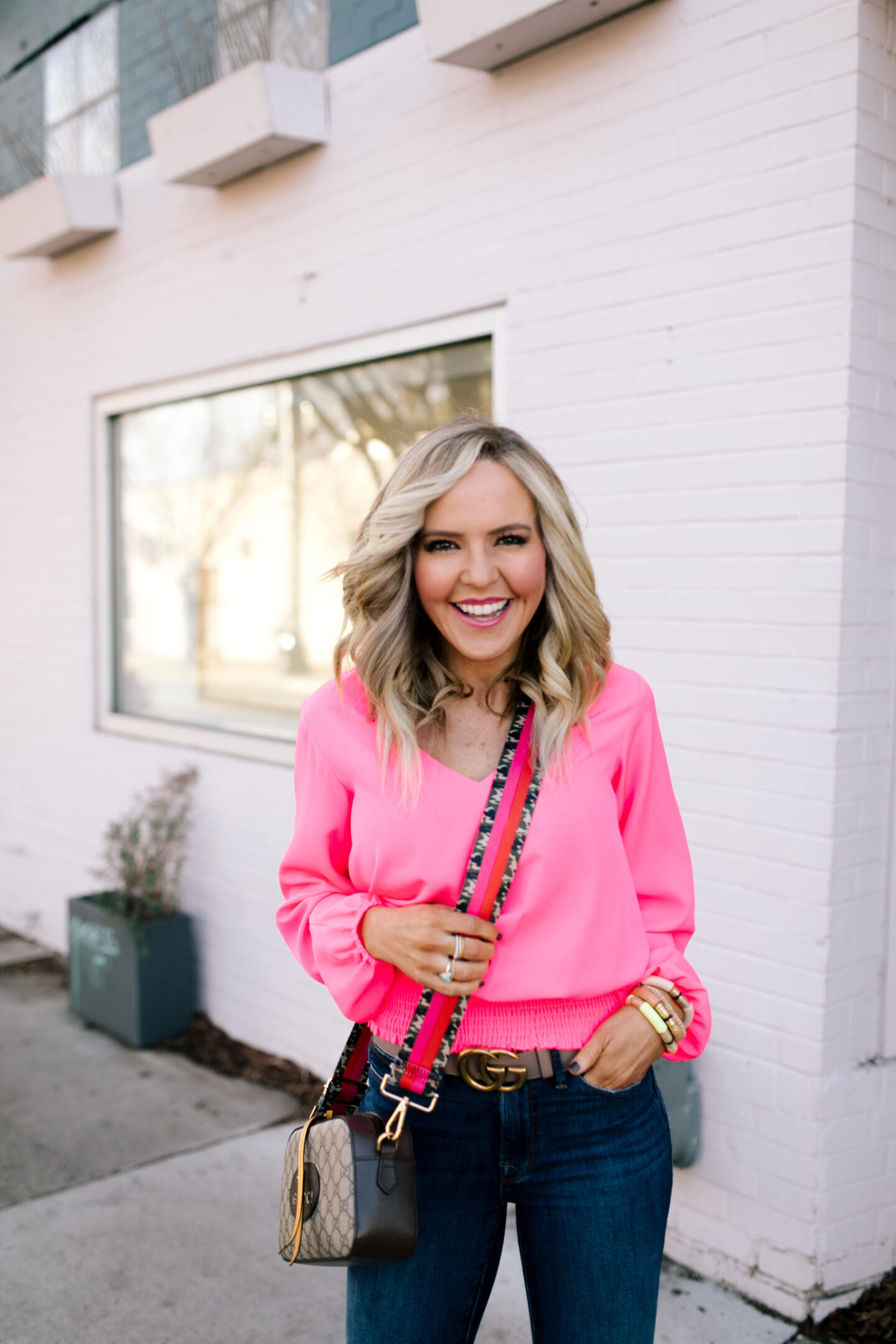 Pink Fashion by popular Nashville fashion blog, Hello Happiness: image of a woman wearing a Pink Hibiscus V-Neck Top from Sail to Sable.