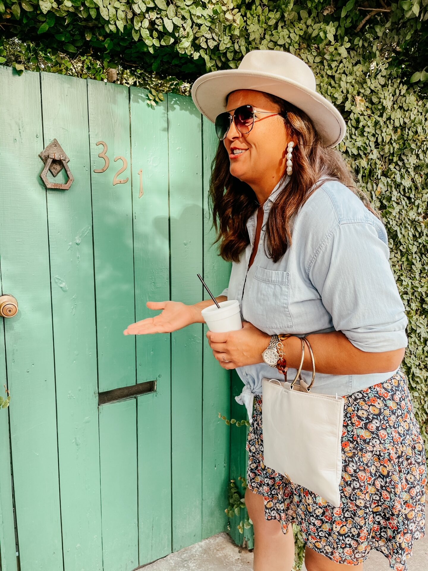 Girls Getaway by popular Nashville travel blog, Hello Happiness: image of a woman standing in front of a green door. 