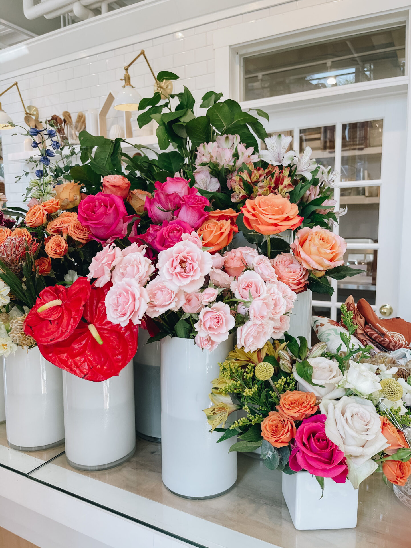 Girls Getaway by popular Nashville travel blog, Hello Happiness: image of fresh flowers in white canisters.