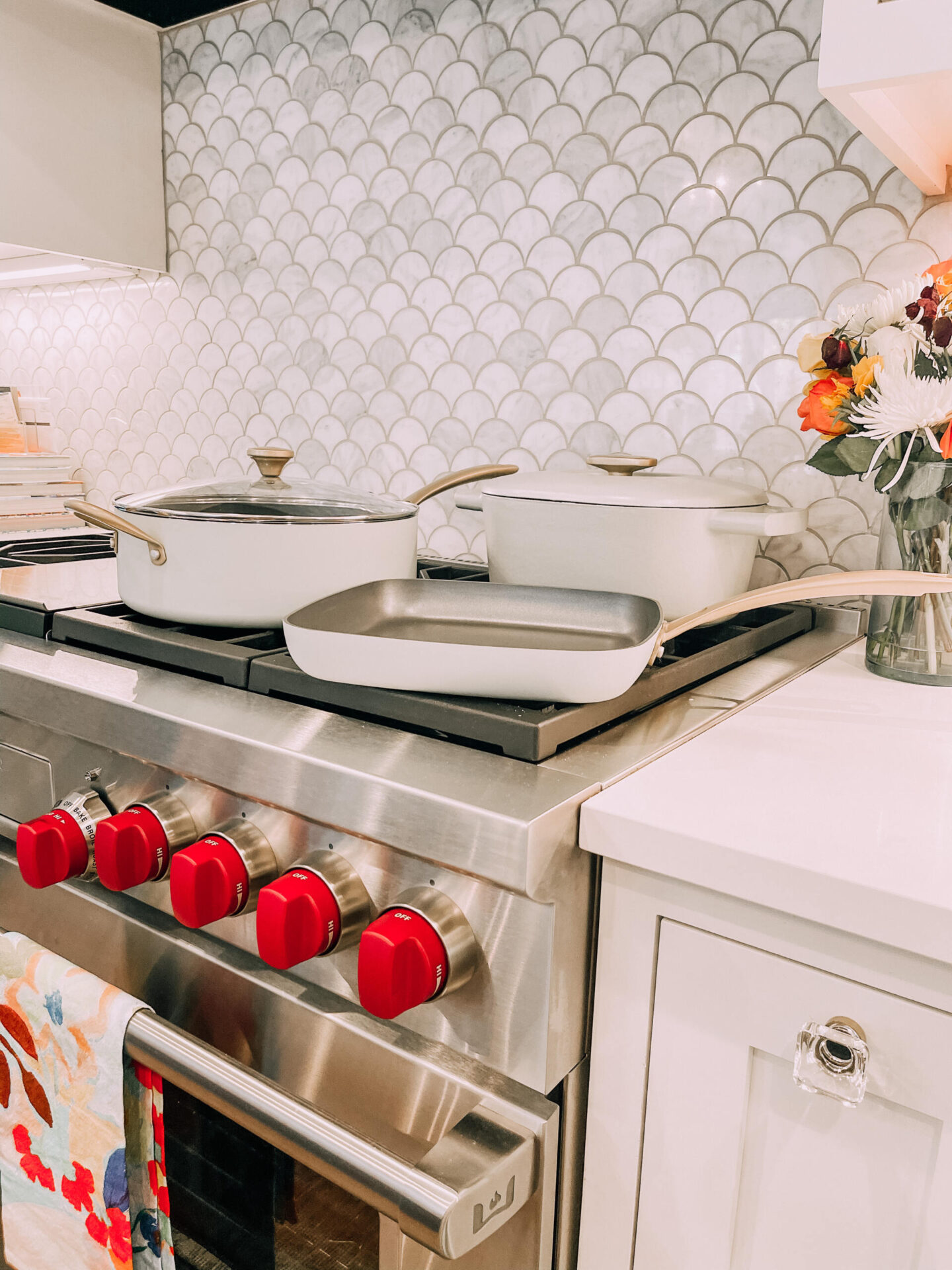 Beautiful by Drew Barrymore by popular Nashville life and style blog, Hello Happiness: image of Beautiful by Drew Barrymore cookware on a gas cooking range. 