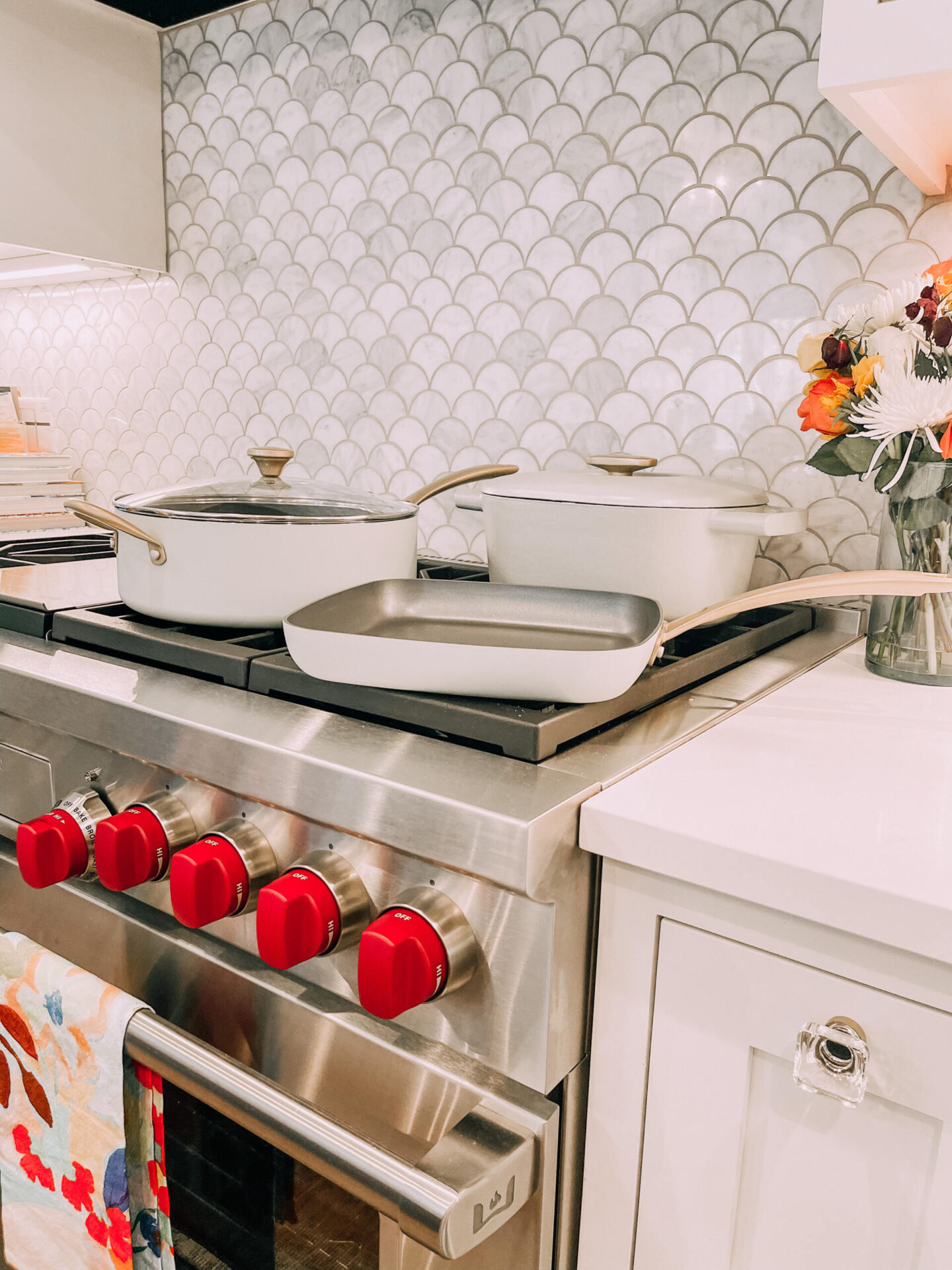 Beautiful by Drew Barrymore by popular Nashville life and style blog, Hello Happiness: image of Beautiful by Drew Barrymore cookware on a gas cooking range.