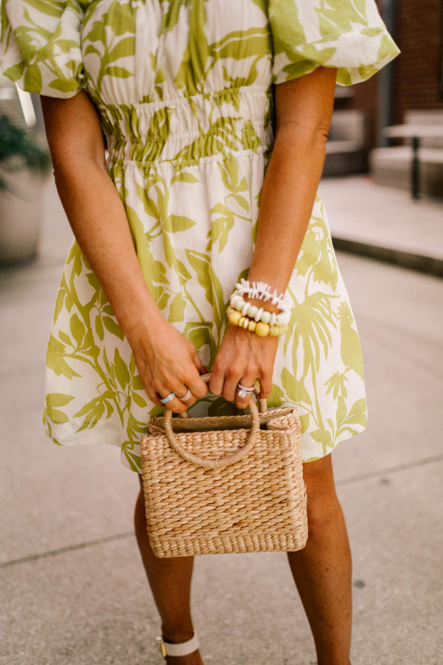 Woven Bag by popular Nashville fashion blog, Hello Happiness: image of a woman wearing a puff sleeve dress and holding a luna small bag.