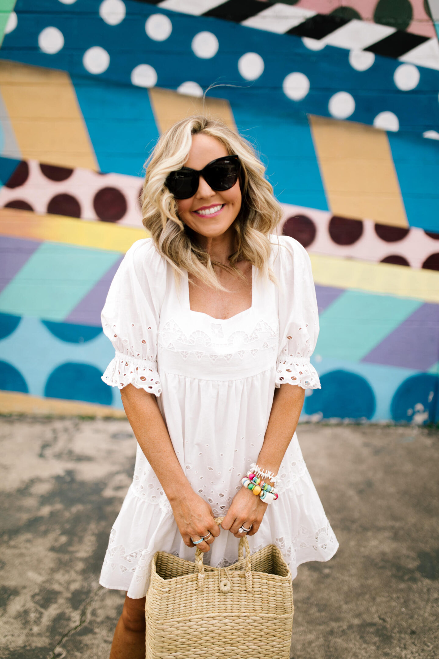 White Dresses by popular Nashville fashion blog, Hello Happiness: image of Natasha Stoneking wearing a Audrina Eyelet Mini dress, Gylian Stacked flatforms, and holding a Mallorca tote.