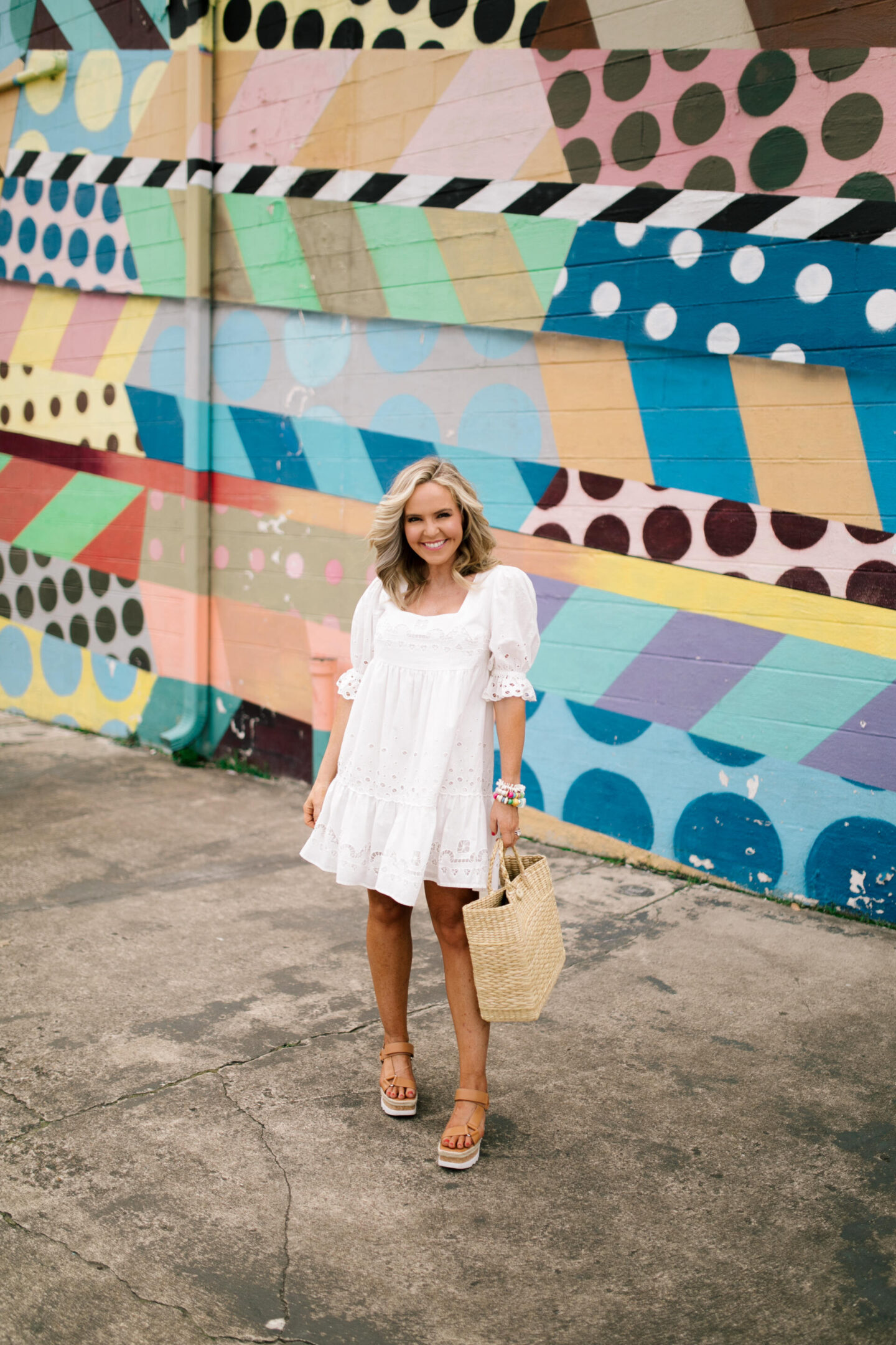 White Dresses by popular Nashville fashion blog, Hello Happiness: image of Natasha Stoneking wearing a Audrina Eyelet Mini dress, Gylian Stacked flatforms, and holding a Mallorca tote.