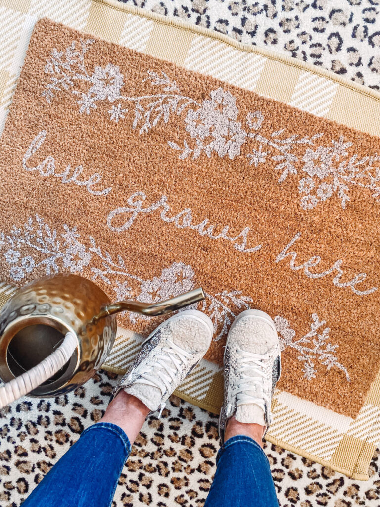 Pantone Color of the Year by popular Nashville life and style blog, Hello Happiness: image of a Love Grows here mat on top of a yellow gingham rug. 