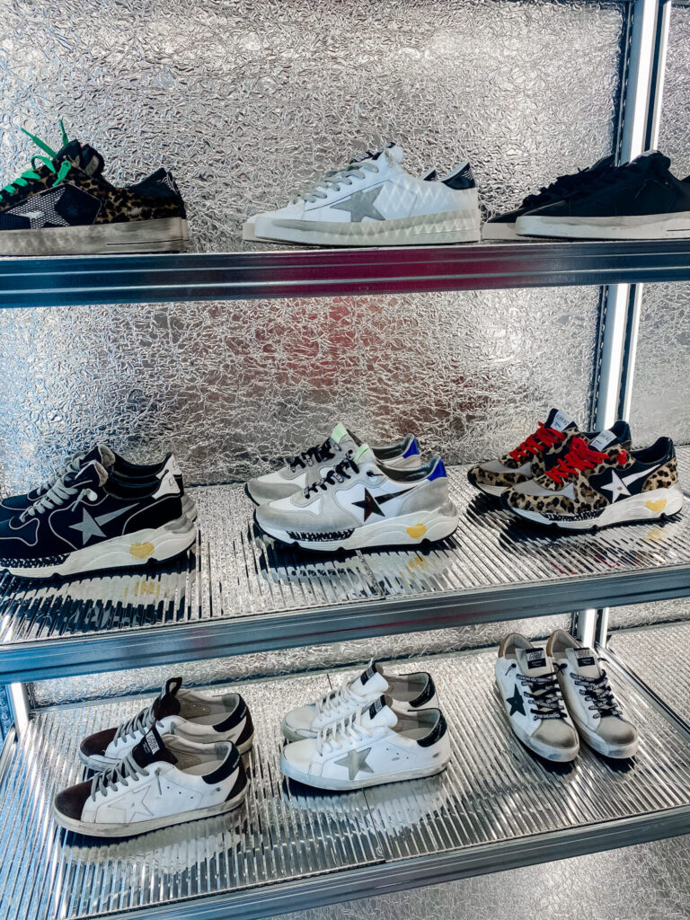 Staycation Ideas by popular Nashville travel blog, Hello Happiness: image of a Golden Goose Sneaker display. 