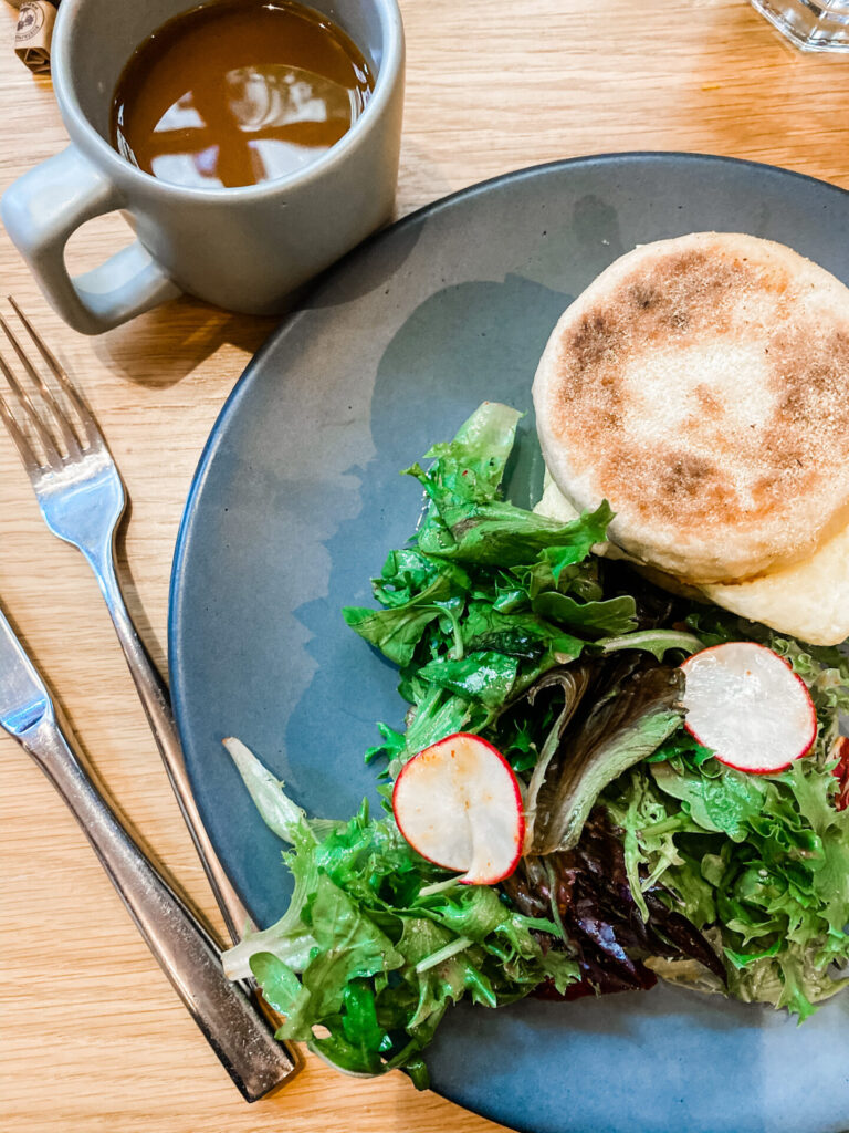 Staycation Ideas by popular Nashville travel blog, Hello Happiness: image of a breakfast sandwich, salad, and cup of melted hot chocolate. 