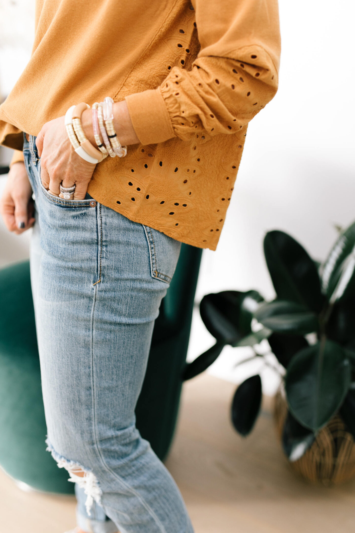Anthro x Pilcro by popular Nashville fashion blog, Hello Happiness: image of Natasha Stoneking wearing some Anthro x Pilcro jeans and a orange eyelet long sleeve top.