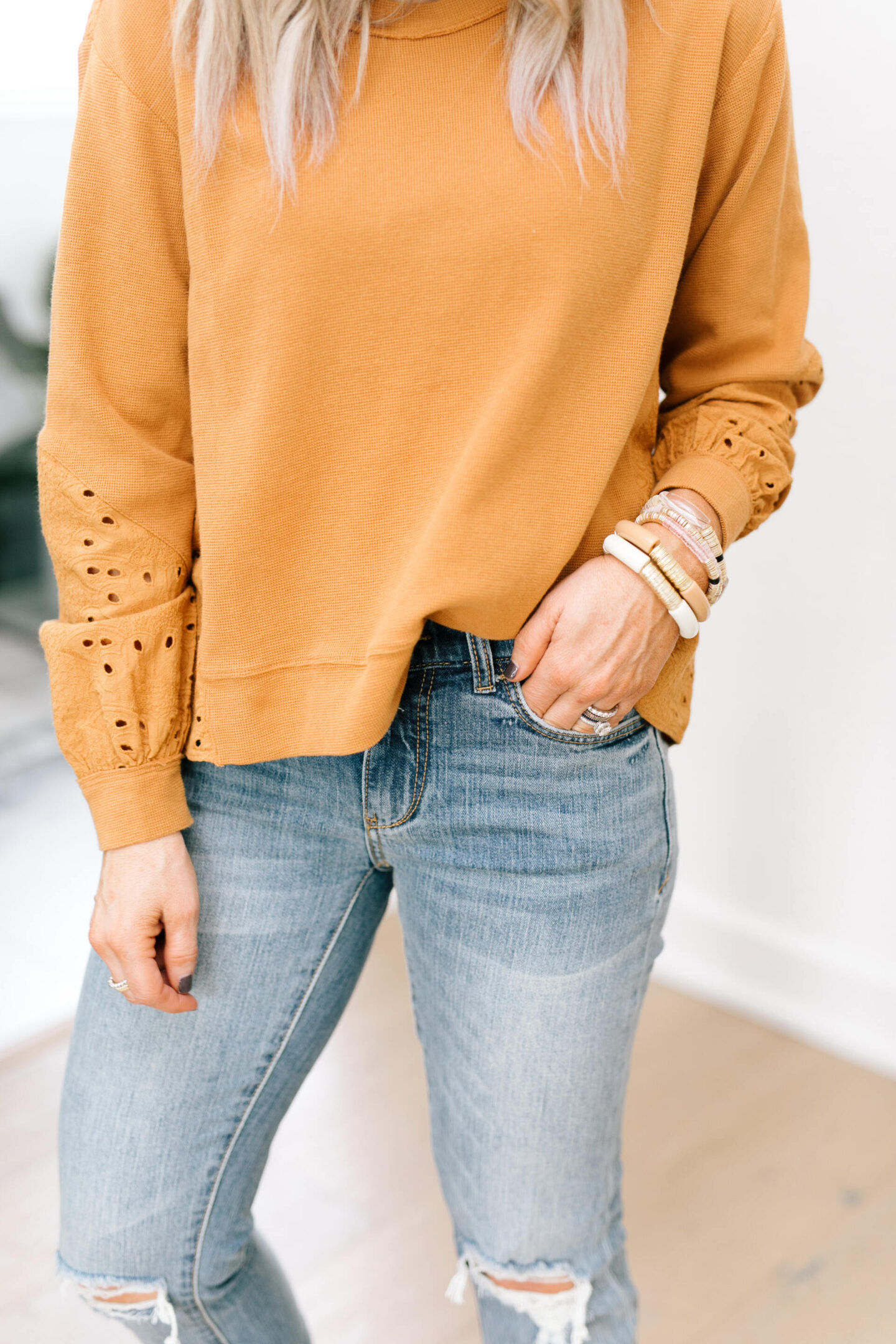 Anthro x Pilcro by popular Nashville fashion blog, Hello Happiness: image of Natasha Stoneking wearing some Anthro x Pilcro jeans and a orange eyelet long sleeve top.