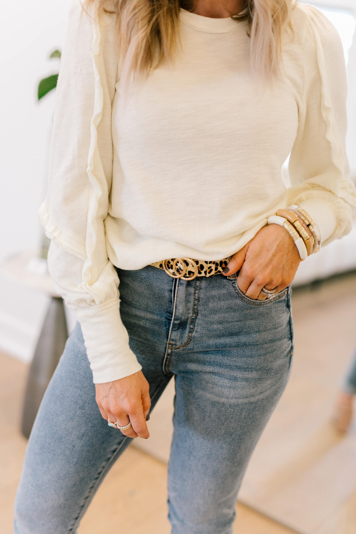 Anthro x Pilcro by popular Nashville fashion blog, Hello Happiness: image of Natasha Stoneking wearing some Anthro x Pilcro jeans, long sleeve cream top, and tan block heel sandals.