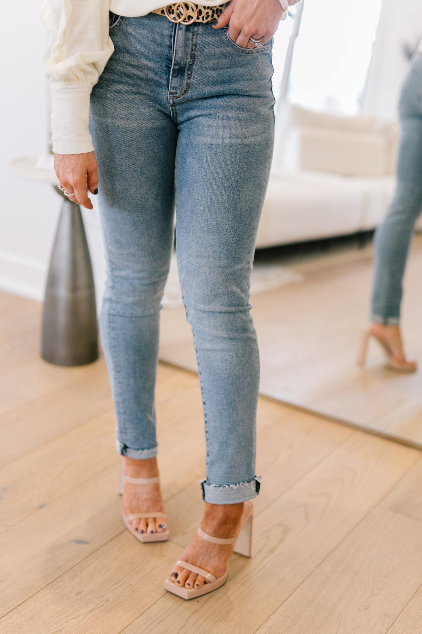 Anthro x Pilcro by popular Nashville fashion blog, Hello Happiness: image of Natasha Stoneking wearing some Anthro x Pilcro jeans, long sleeve cream top, and tan block heel sandals.