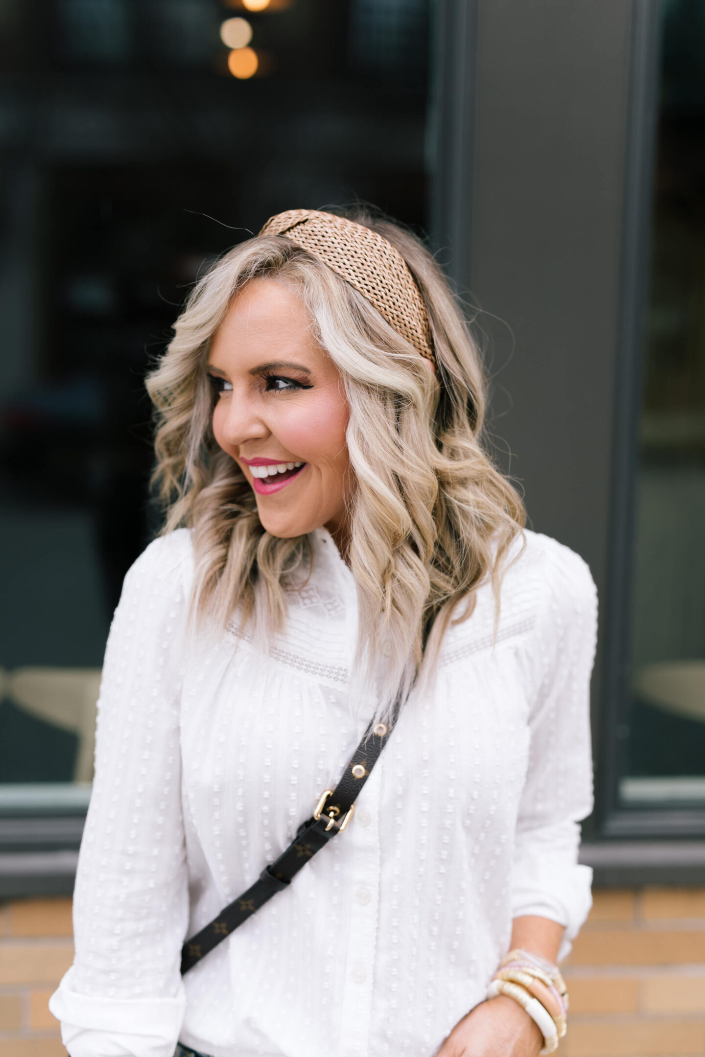 Anthropologie Sale by popular Nashville life and style blog, Hello Happiness: image of Natasha Stoneking wearing a Anthropologie Dylan woven headband and white swiss dot button up top.