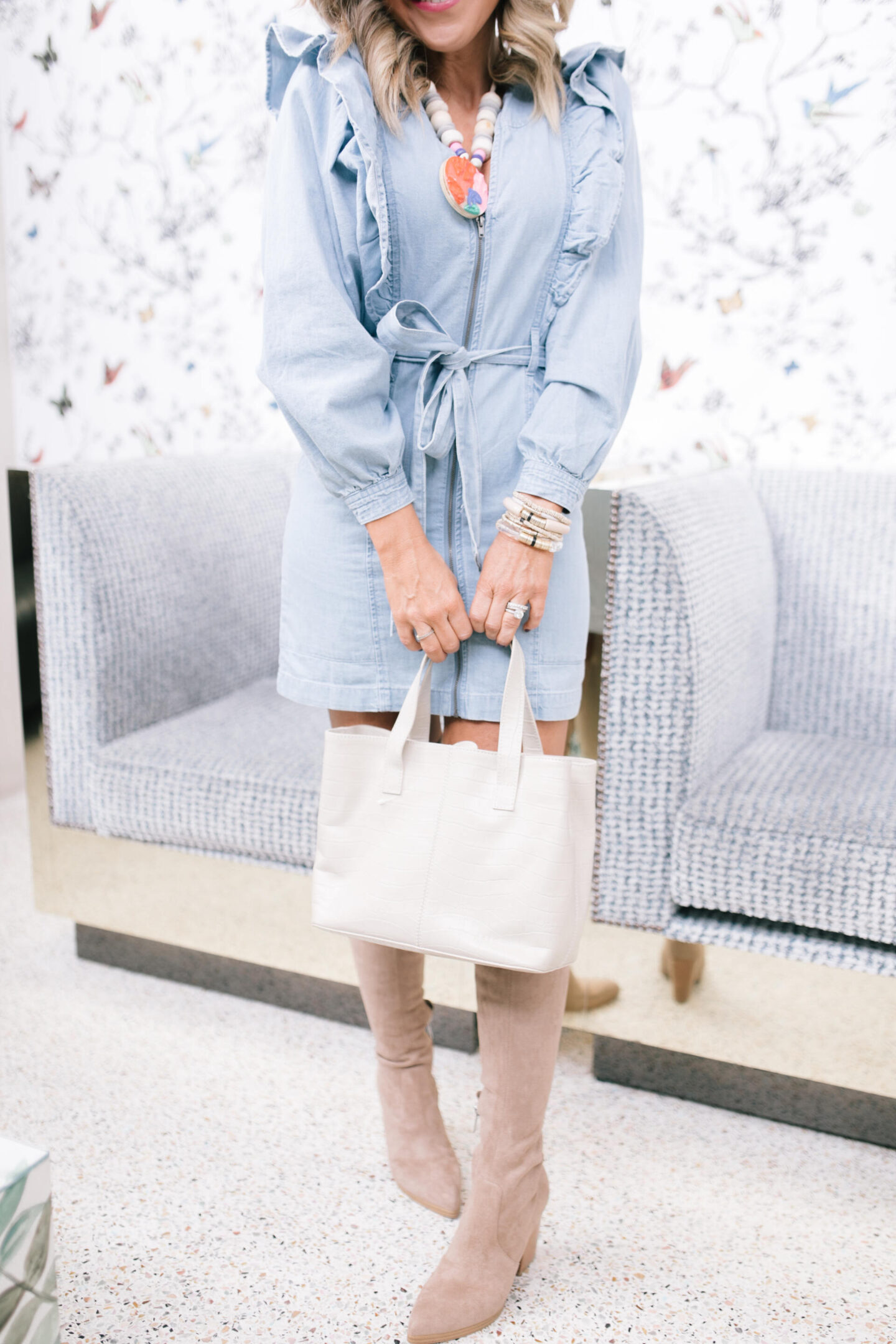 Denim Dresses by popular Nashville fashion blog, Hello Happiness: image of a woman wearing a Imogene mini dress, Vince Camuto over the knee boots and holding a Able Ilse tote.