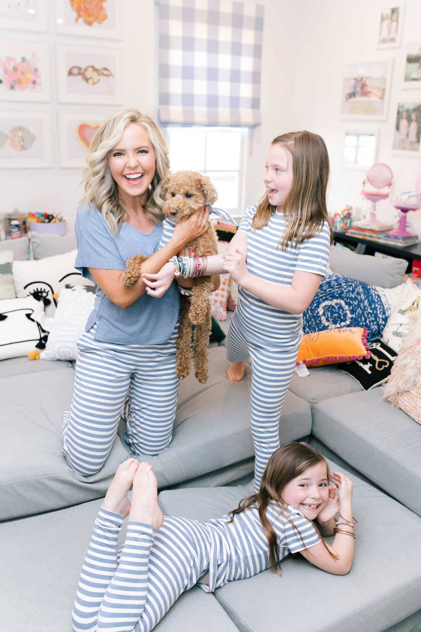 Memorial Day Sales by popular Nashville life and style blog, Hello Happiness: image of Natasha Stoneking and her daughter wearing matching Soma pajamas sets and holding their golden doodle dog. 